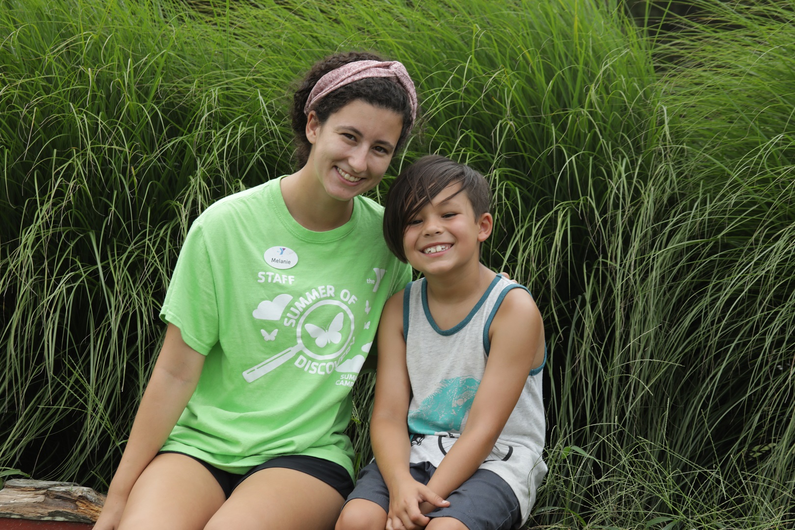 Child and volunteer smiling at YMCA camp Child and volunteer smiling at YMCA camp