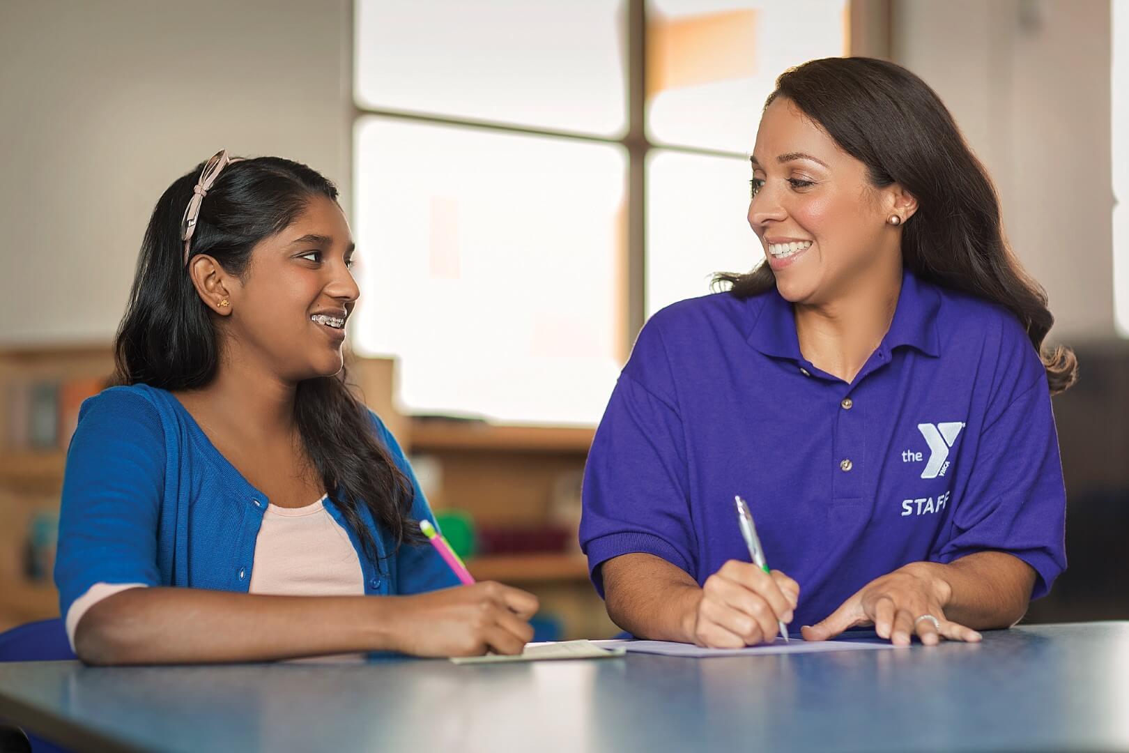 YMCA Louisville staff working with teen for babysitter training YMCA Louisville staff working with teen for babysitter training