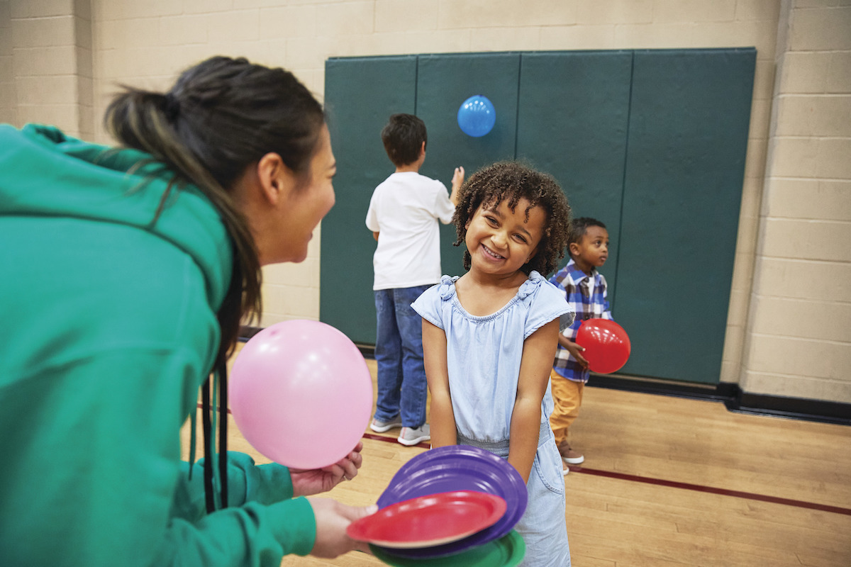 YMCA teen playing with little girl after school YMCA teen playing with little girl after school