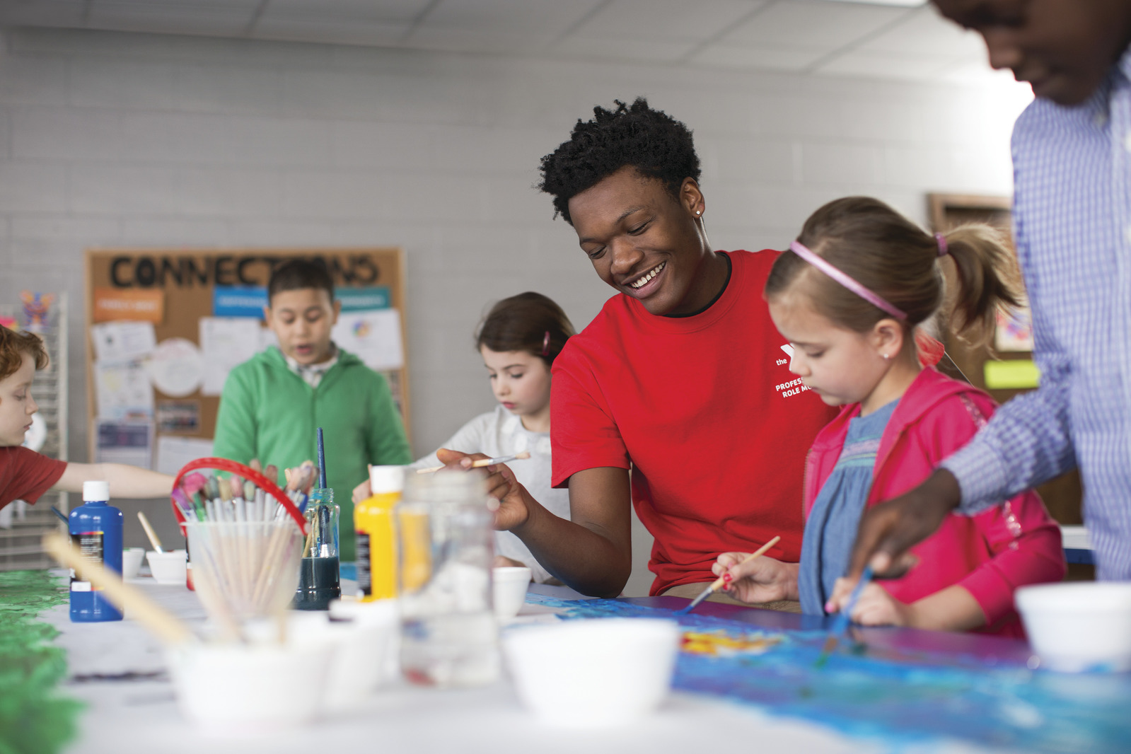YMCA children laughing together while painting YMCA children laughing together while painting