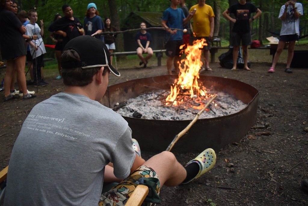 Camper roasts smores over the fire pit at YMCA Camp Piomingo Camper roasts smores over the fire pit at YMCA Camp Piomingo