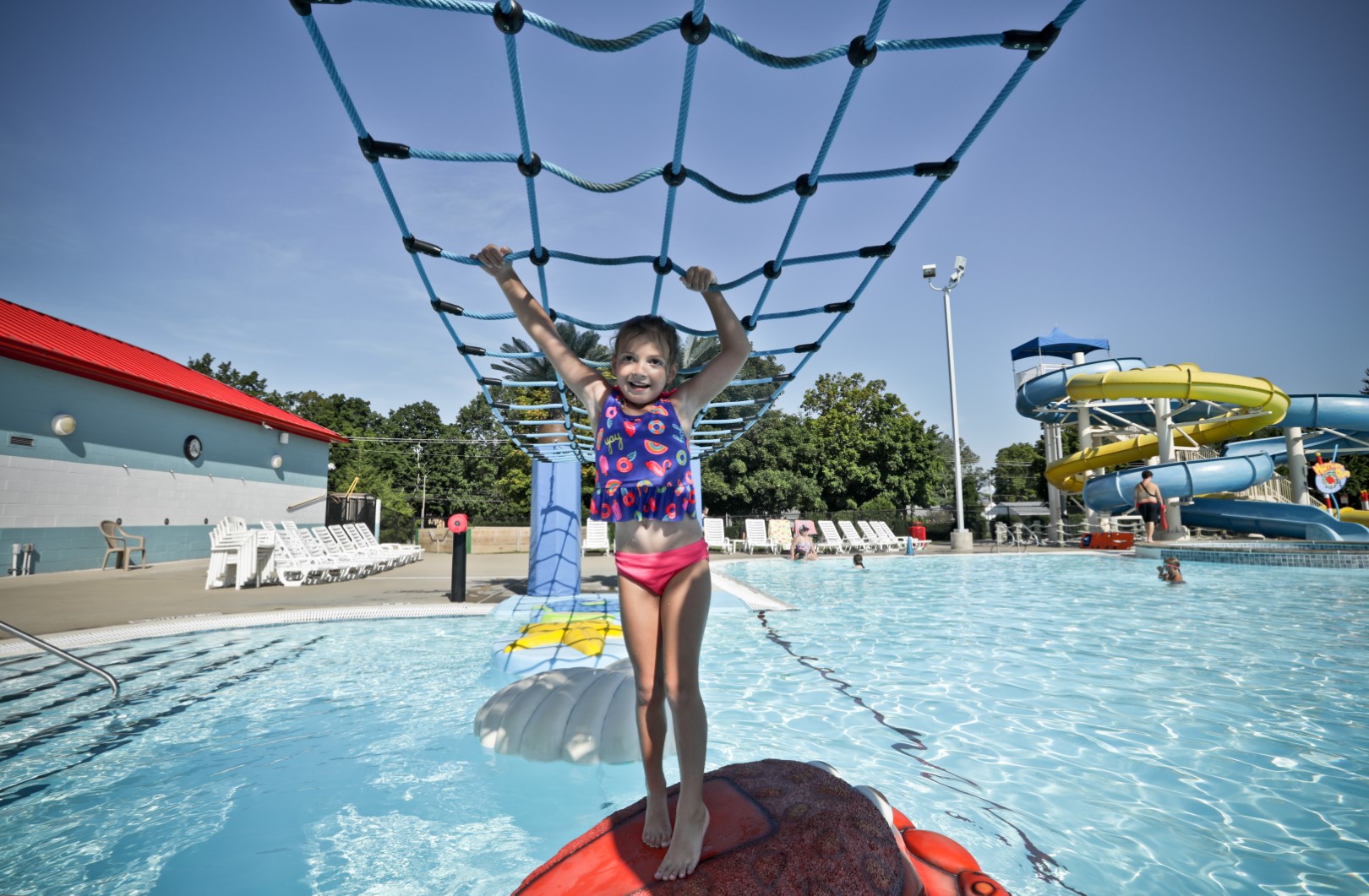Child crossing pool with hanging net at Calypso Cove Waterpark