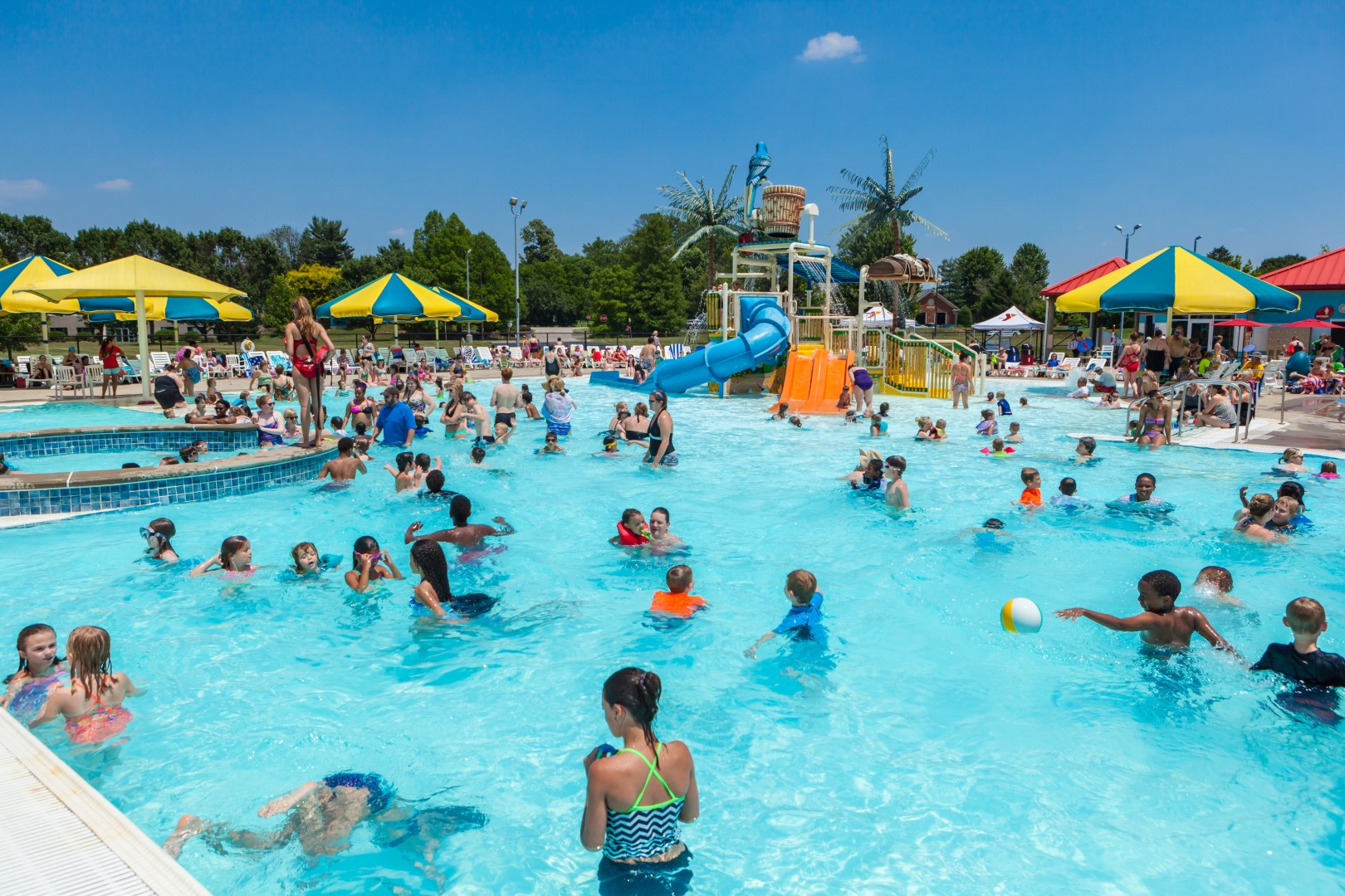 Kids and adults splashing in the pool at the YMCA Louisville Calypso Cove Waterpark