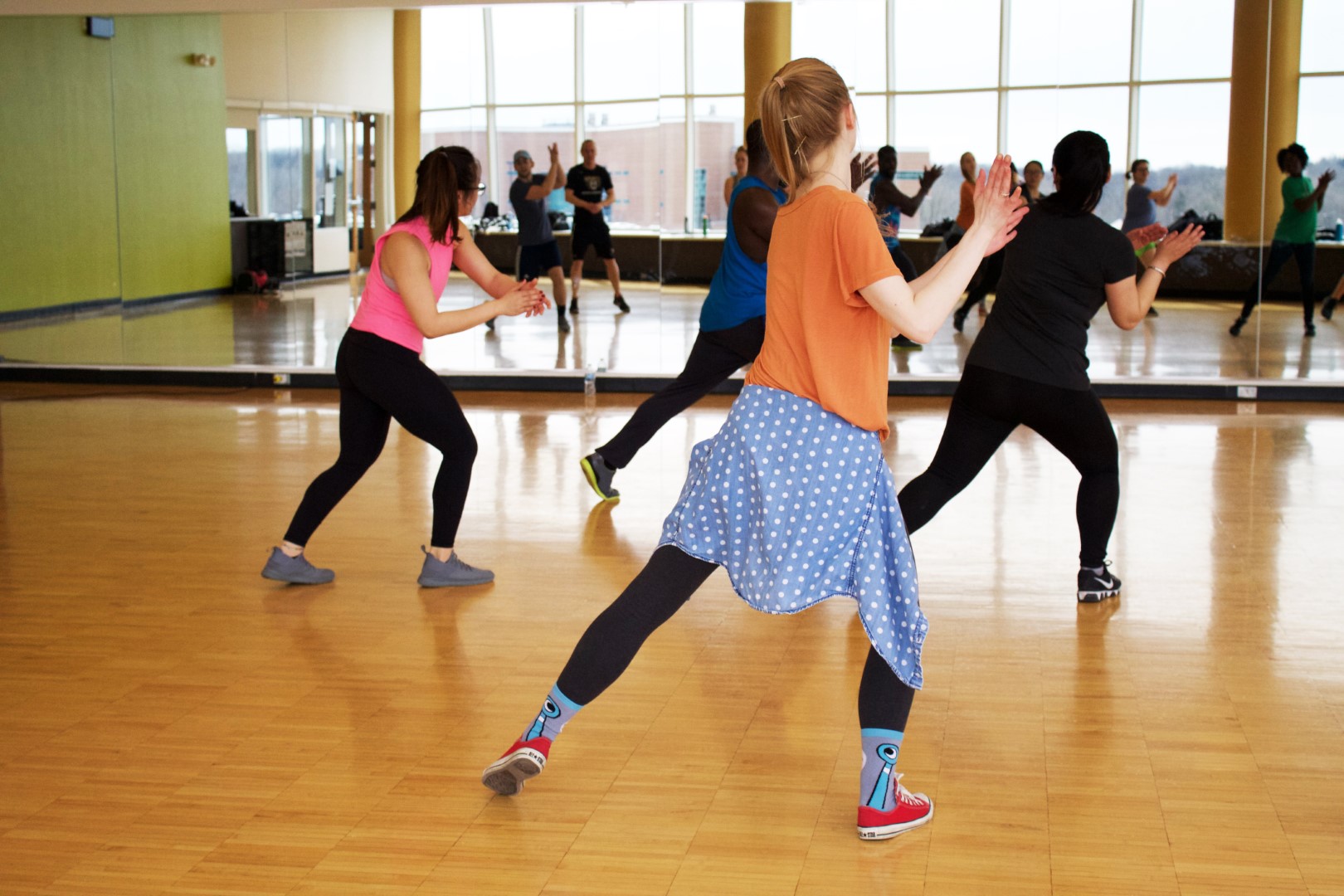 Adults dancing and clapping at group dance class Adults dancing and clapping at group dance class