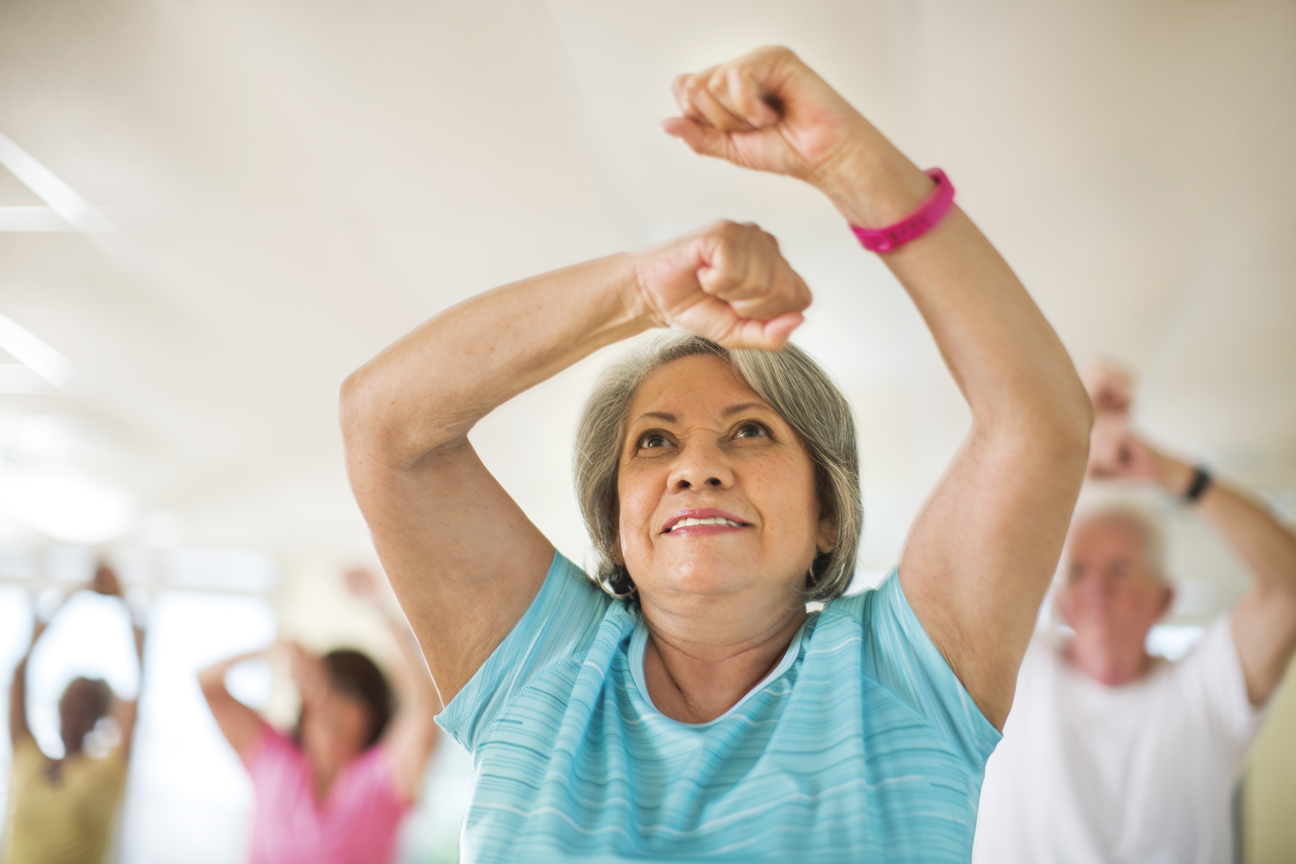 Older woman working out at group fitness class at YMCA Louisville Older woman working out at group fitness class at YMCA Louisville