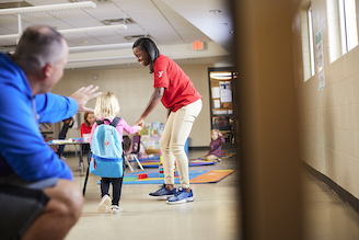 Parent dropping off child a YMCA location Parent dropping off child a YMCA location
