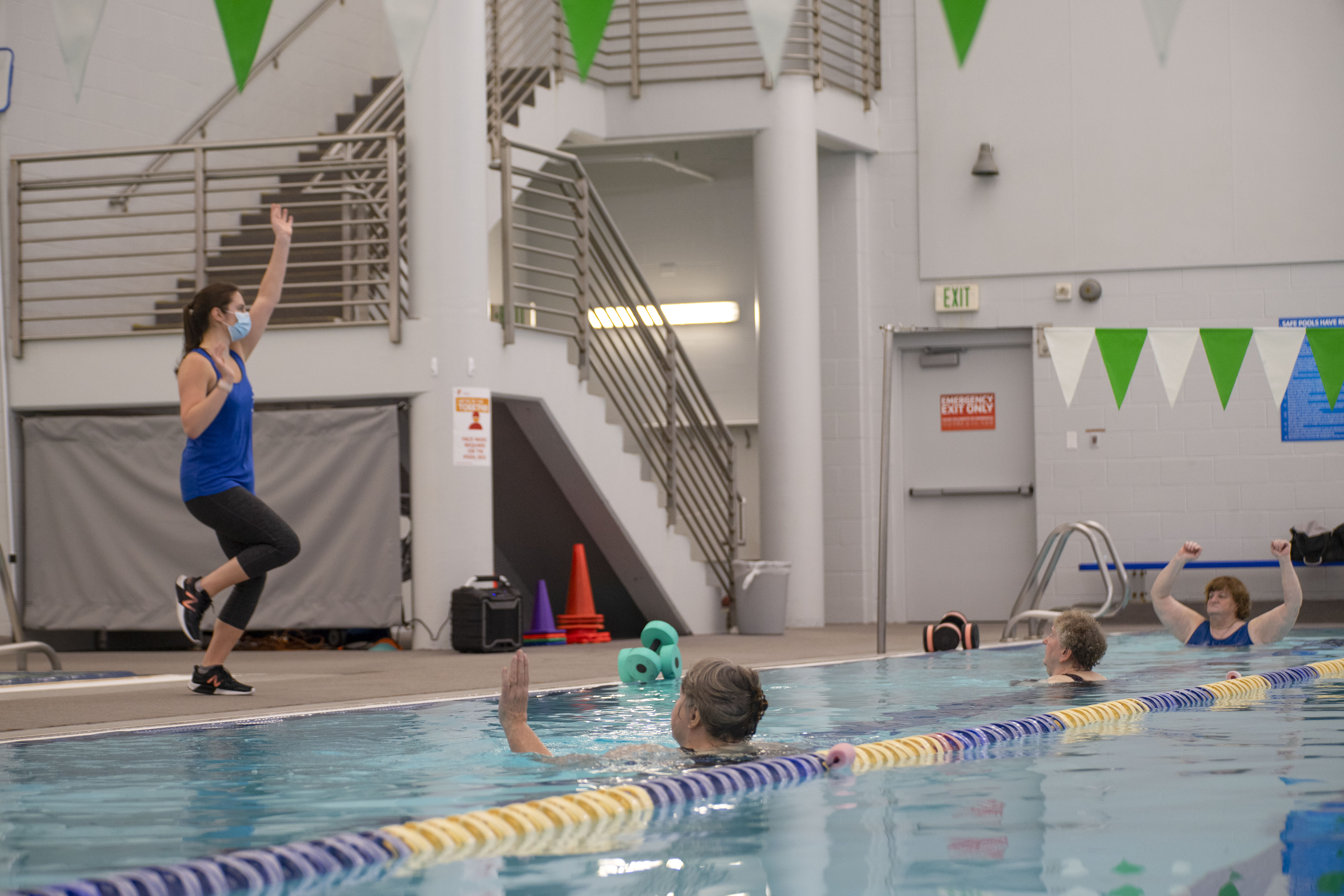 Instructor leading adult water fitness class in YMCA Louisville swimming pool Instructor leading adult water fitness class in YMCA Louisville swimming pool