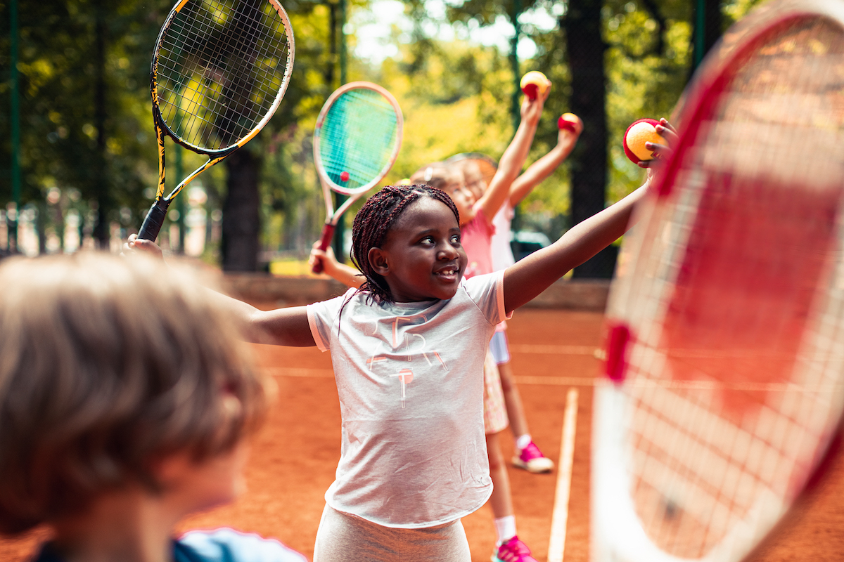 Kids playing tennis for YMCA Louisville youth fitness program Kids playing tennis for YMCA Louisville youth fitness program