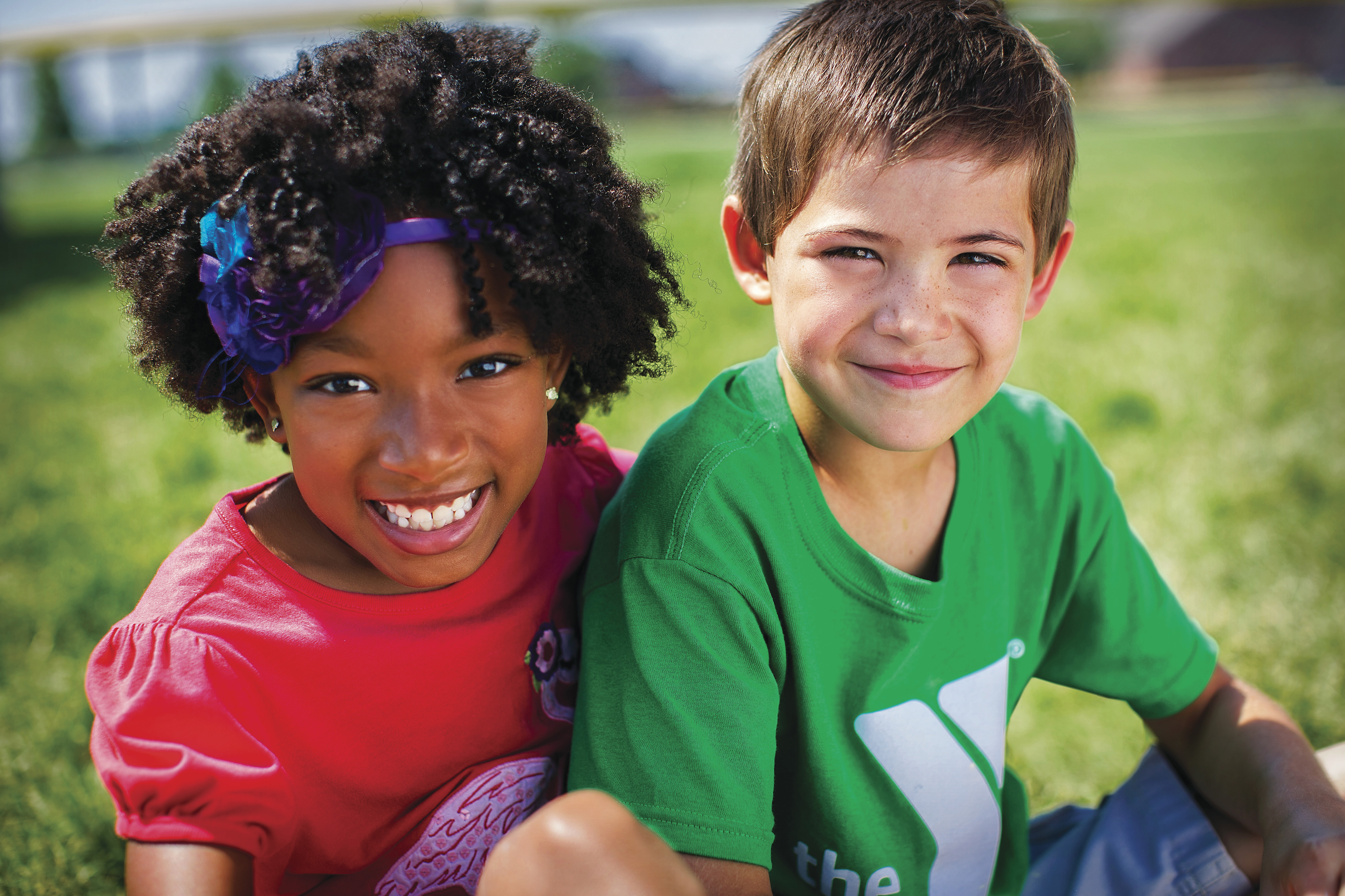 Smiling girl and boy sitting outdoors Smiling girl and boy sitting outdoors