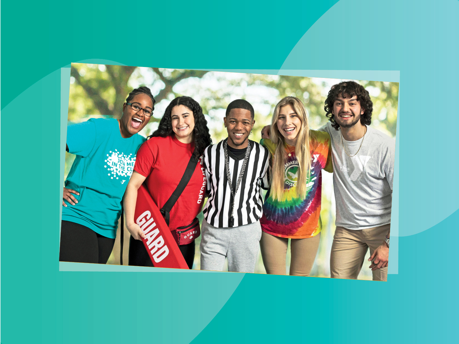 5 young YMCA staff members standing together outdoors and smiling 5 young YMCA staff members standing together outdoors and smiling