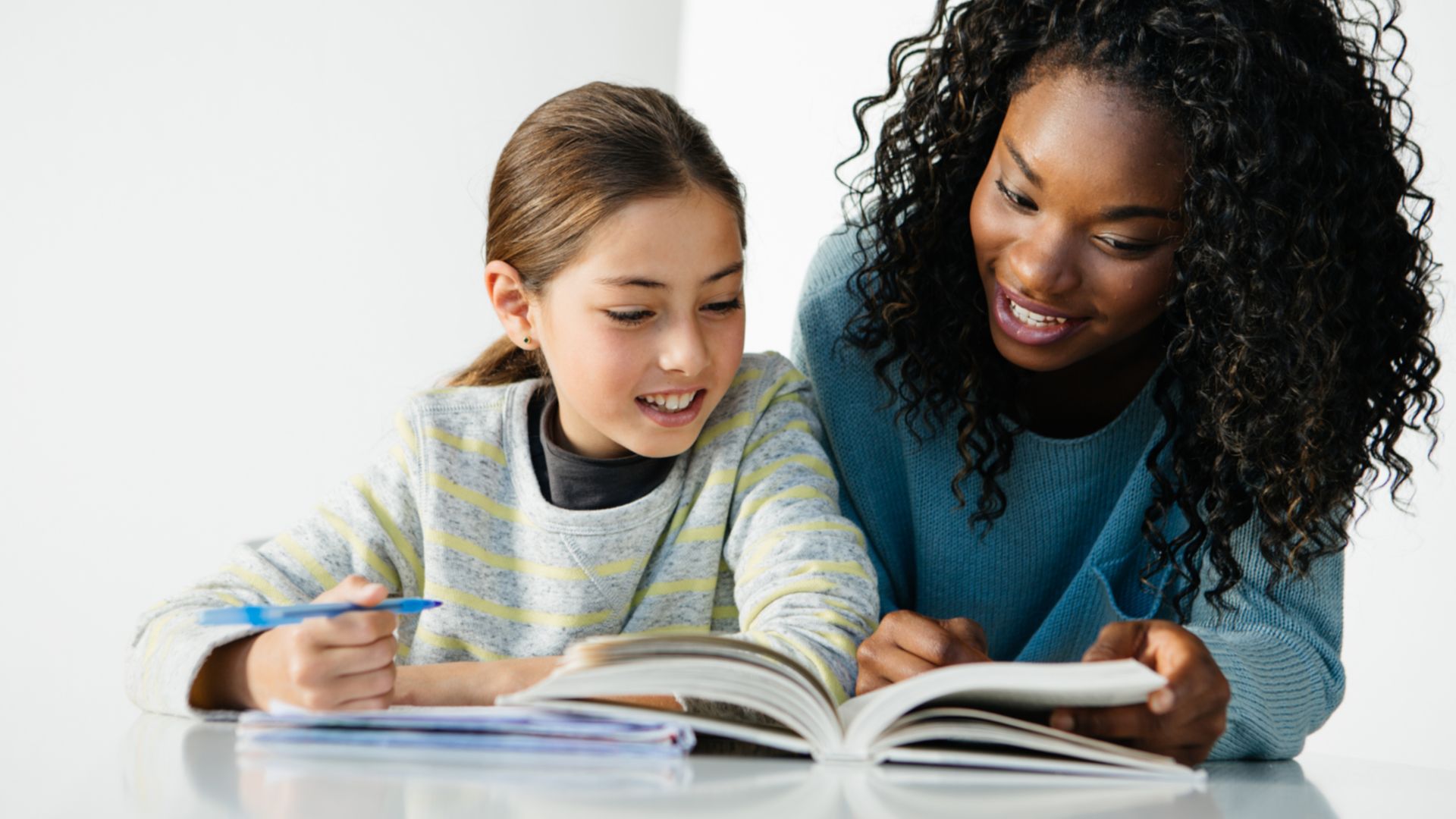 Tutor reading a book with a child Tutor reading a book with a child