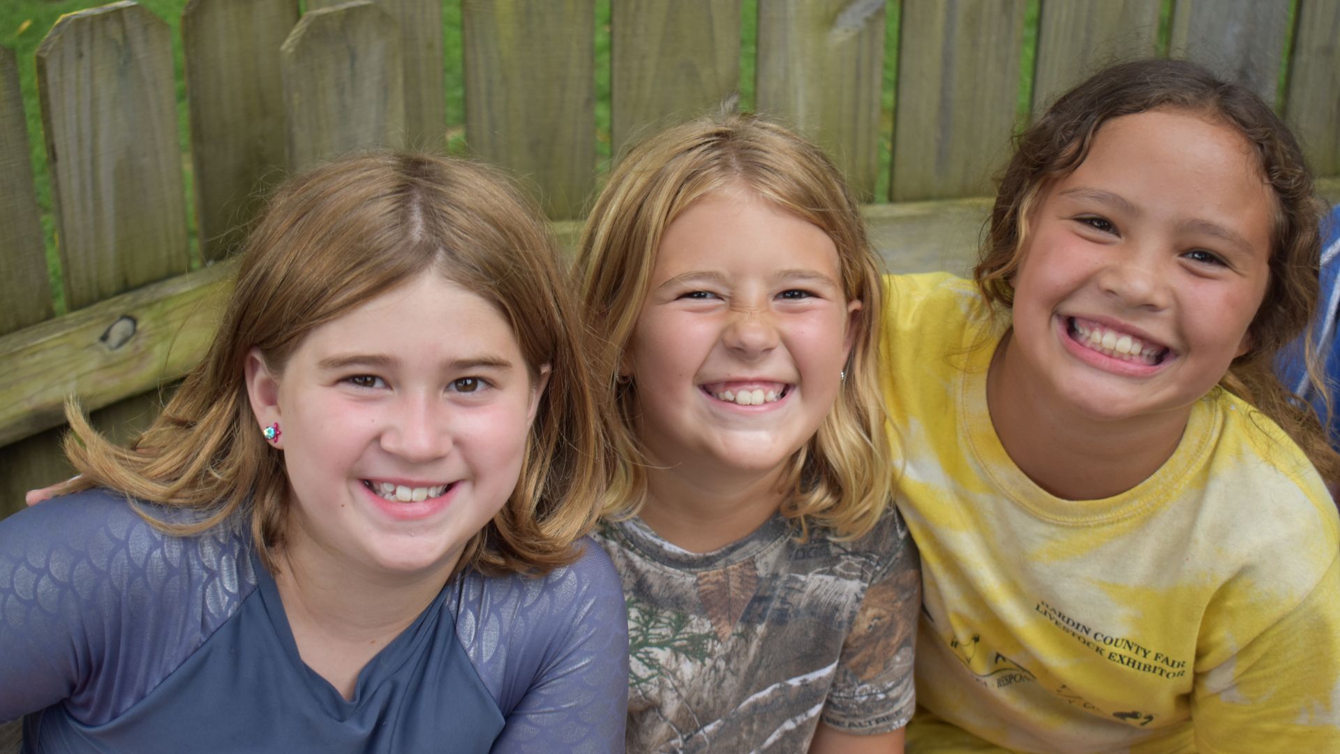 Group of campers sitting together smiling Group of campers sitting together smiling