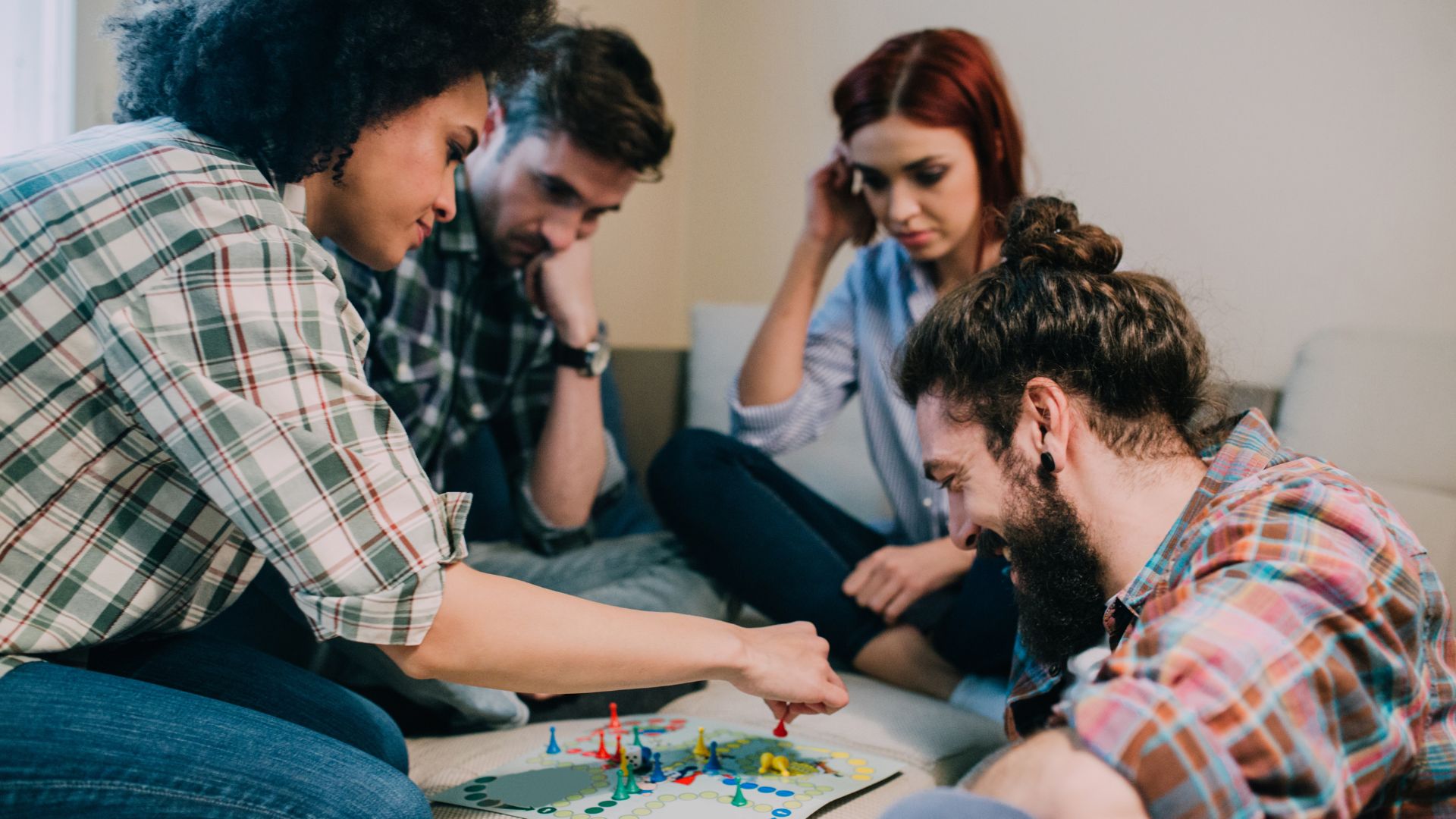 Group of teens playing a board game together Group of teens playing a board game together
