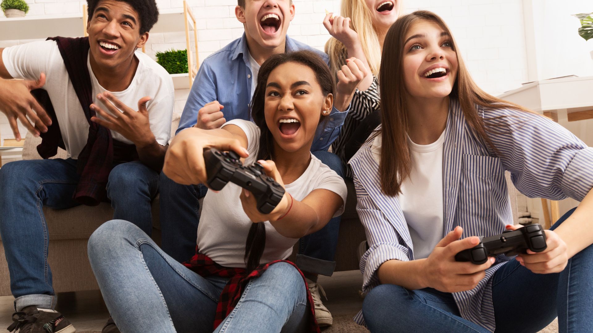 Group of teens playing video games together Group of teens playing video games together