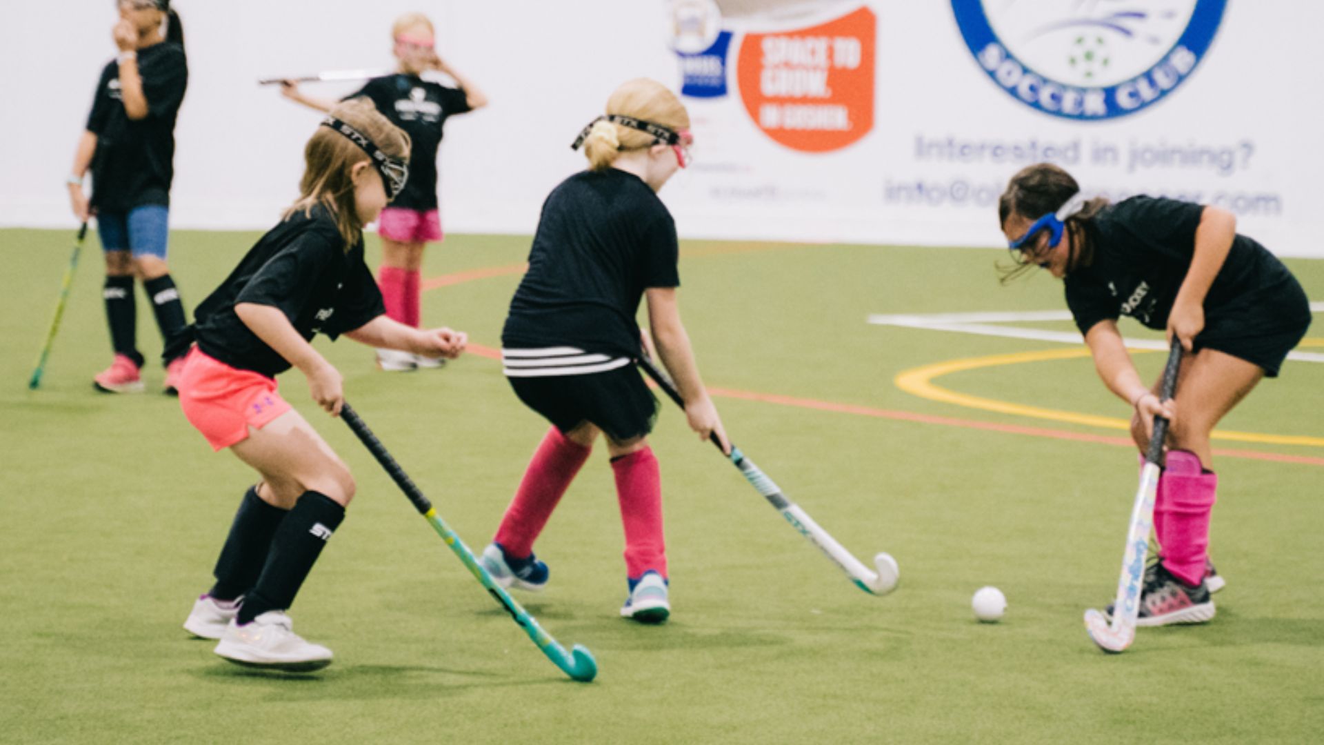 Group of kids learning how to play field hockey Group of kids learning how to play field hockey