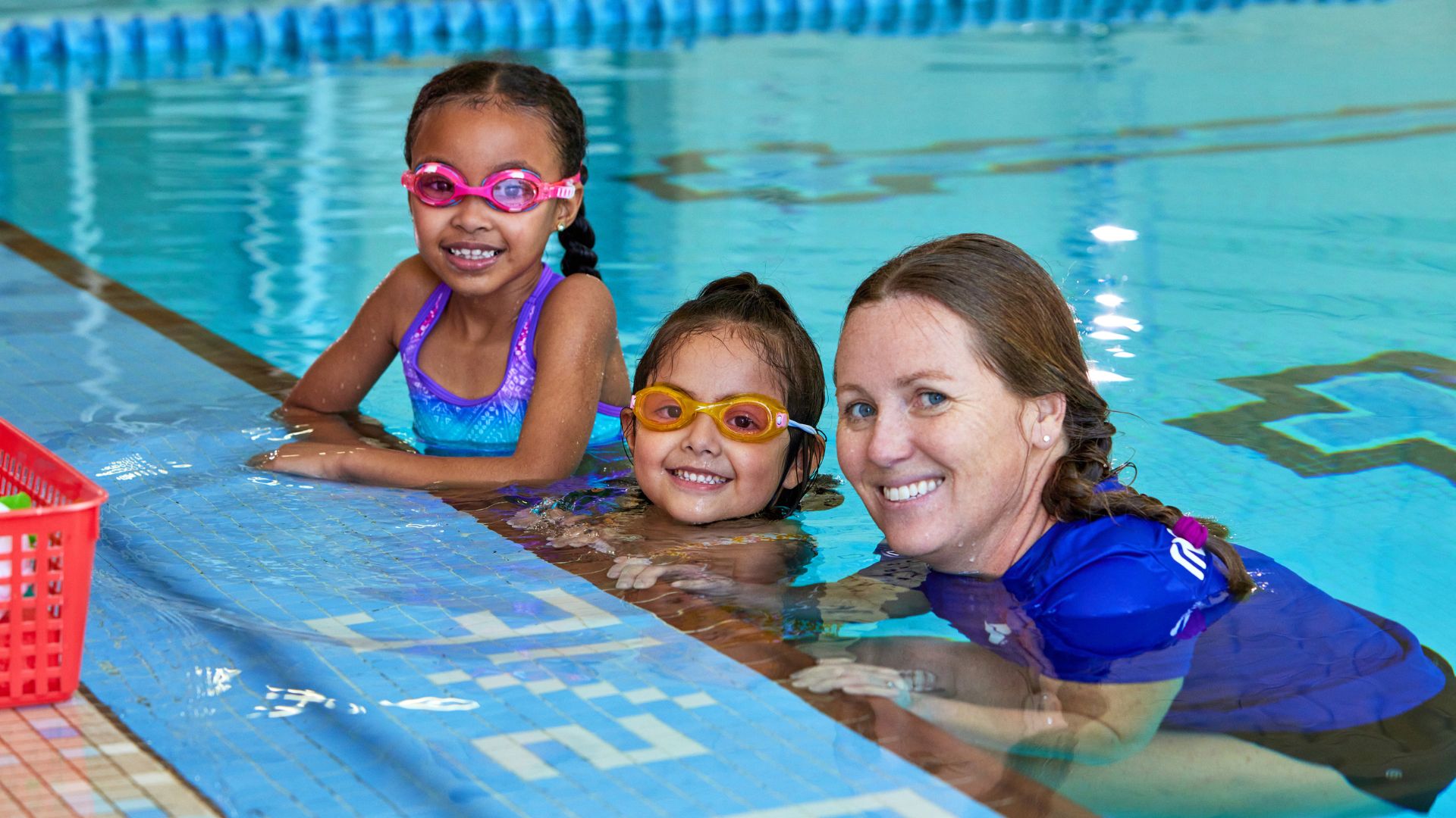 Kids with a YMCA swim instructor in the pool Kids with a YMCA swim instructor in the pool