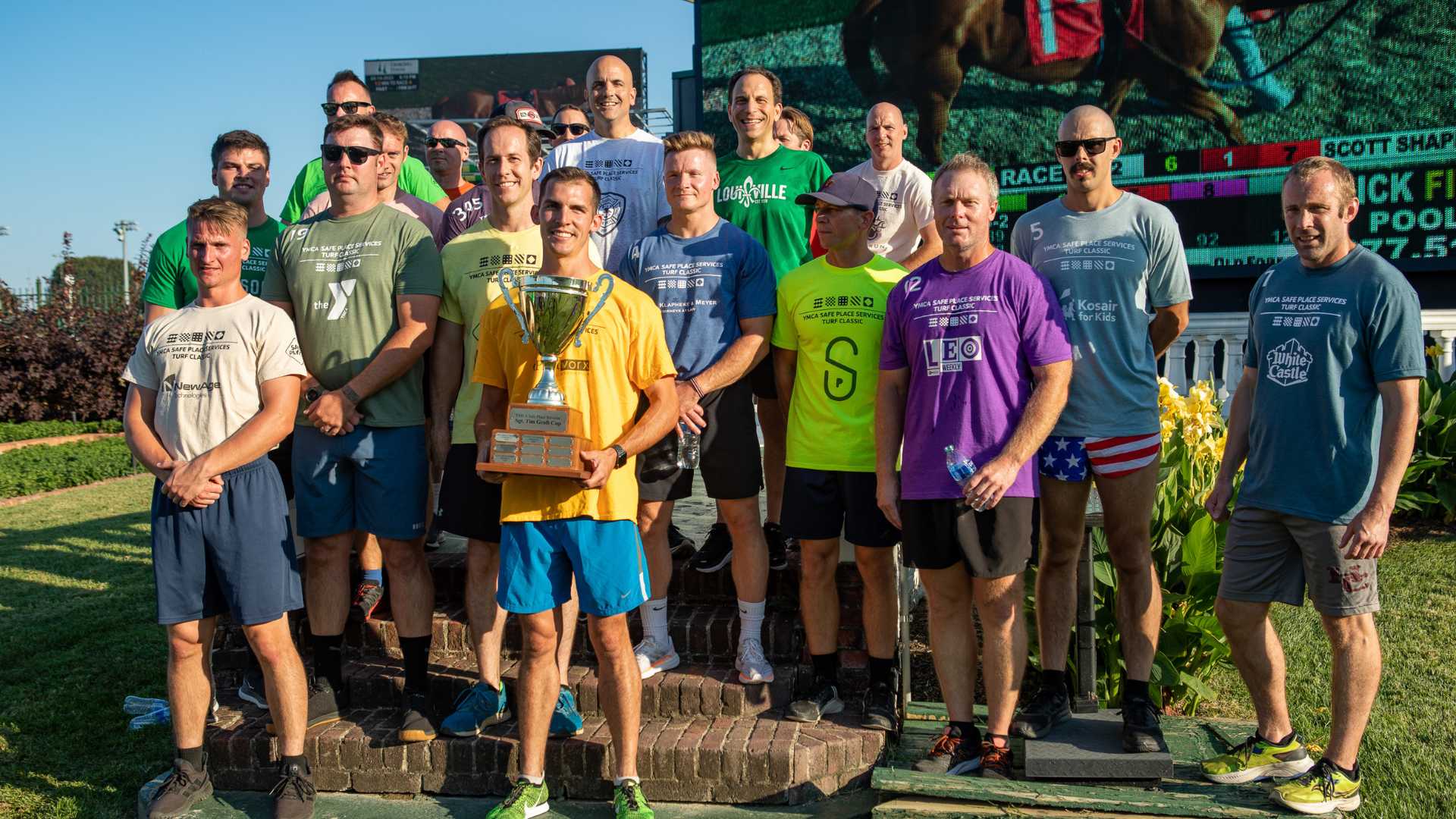 Group of runners with trophy