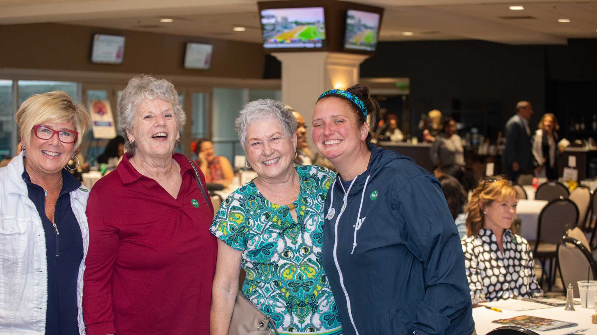 Four women standing next to each other