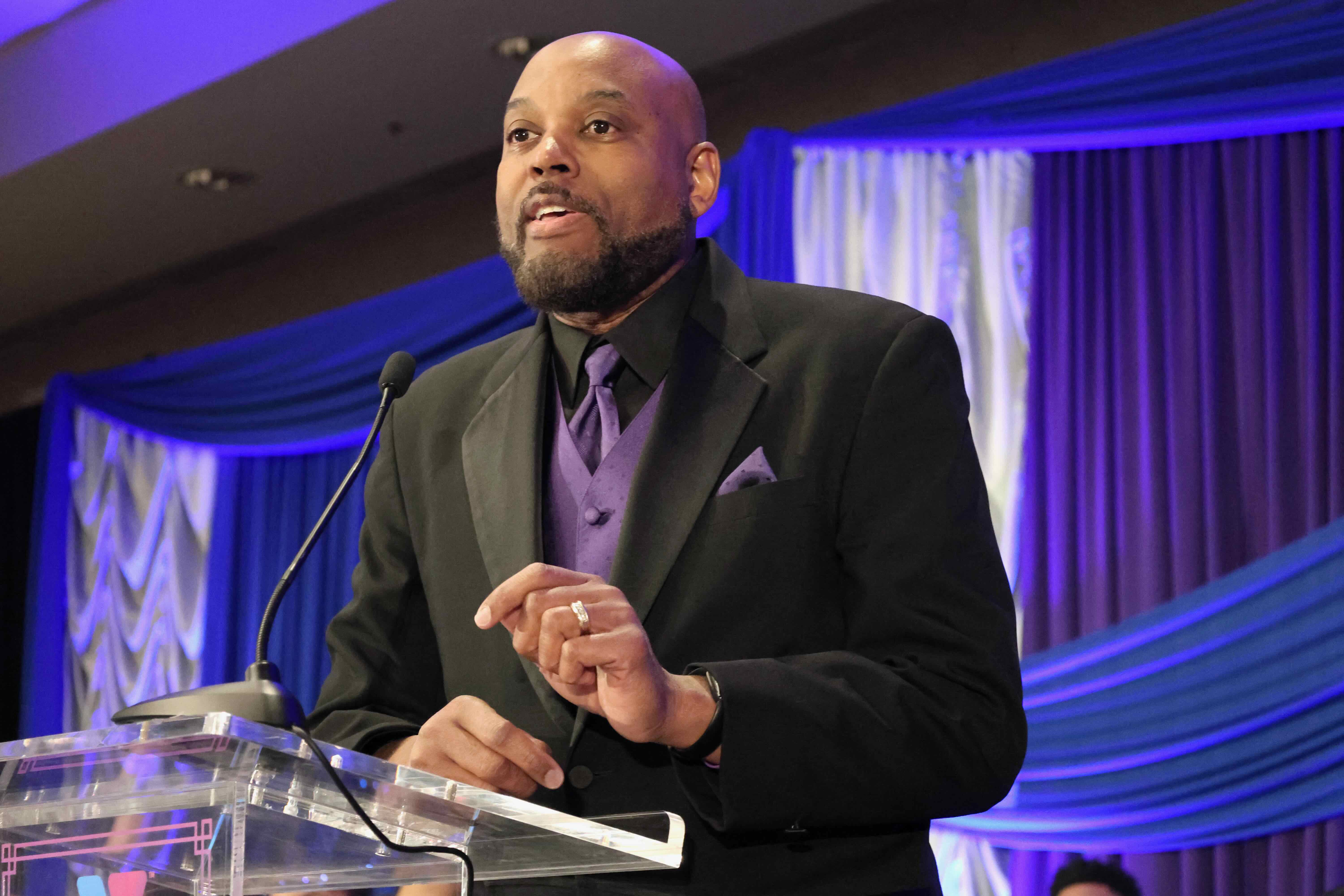 Speaker standing on podium giving a speech
