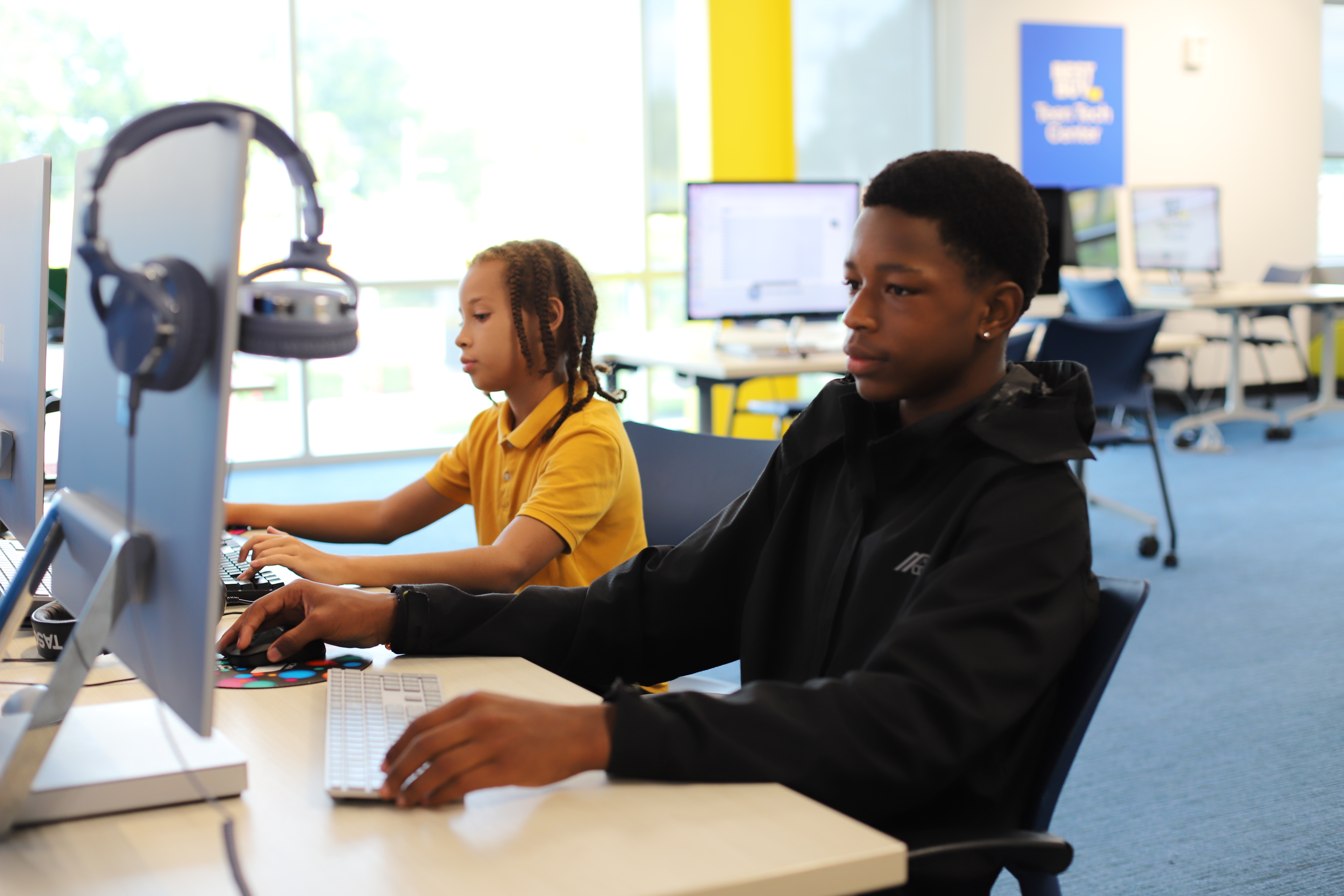 Teens looking at computer screens