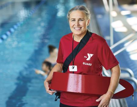 Woman lifeguard smiling at YMCA swimming pool Woman lifeguard smiling at YMCA swimming pool