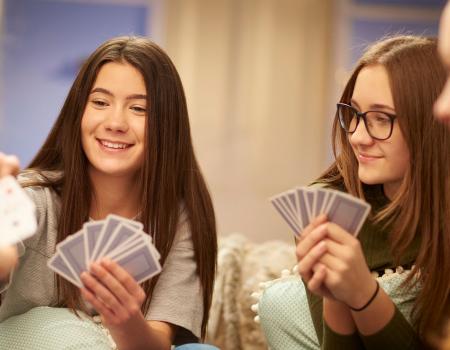 Group of teens playing cards Group of teens playing cards