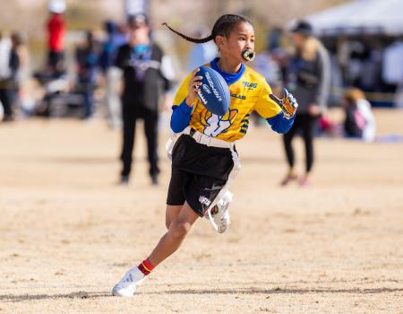 Girl carrying a football while running Girl carrying a football while running