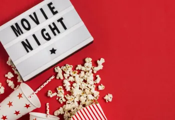 Movie night sign with popcorn and drink cups with straws