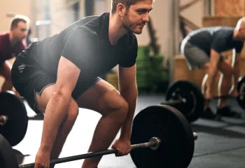 Group of men deadlifting