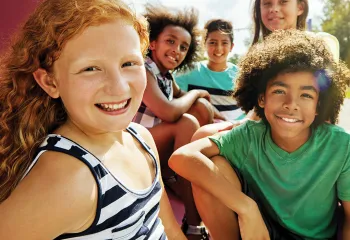 Group of kids sitting outside