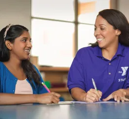 YMCA Louisville staff working with teen for babysitter training