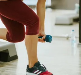 Person lifting a handweight on a workout step
