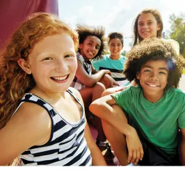 Group of kids sitting outside