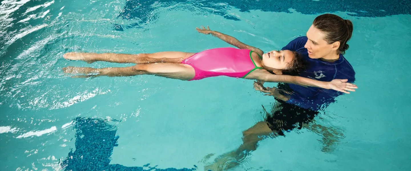 YMCA Louisville coach teaching children during swimming lessons