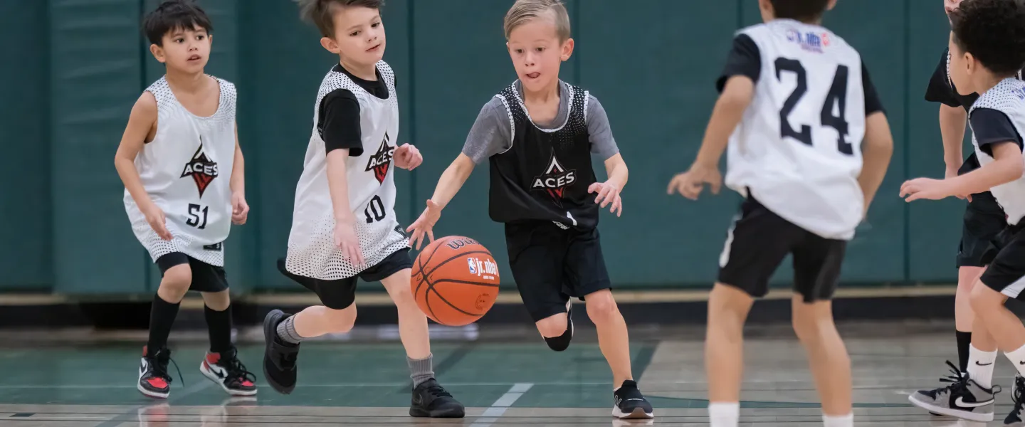 Kids playing basketball at the gym