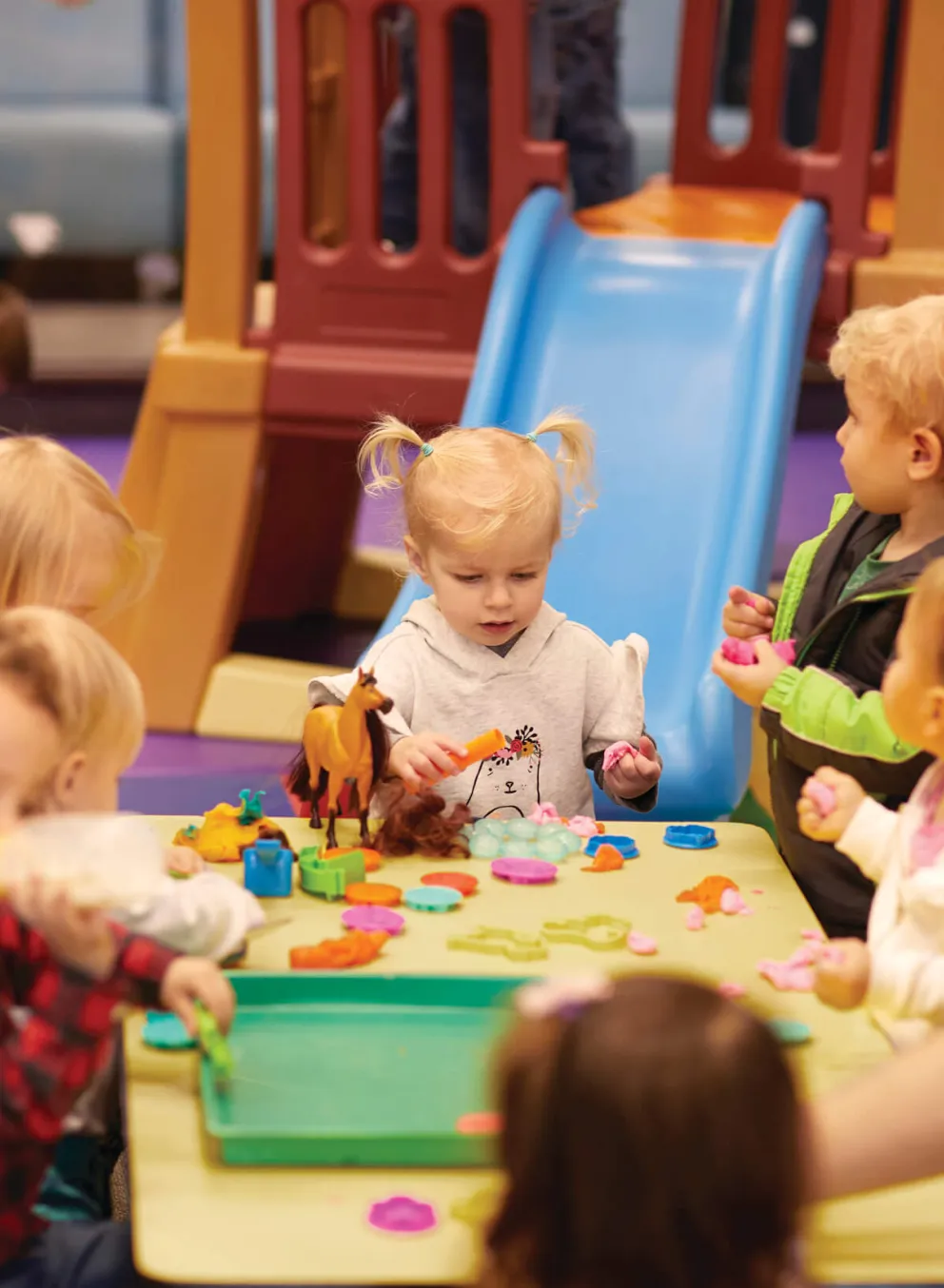 YMCA staff crafting with kids during child care program