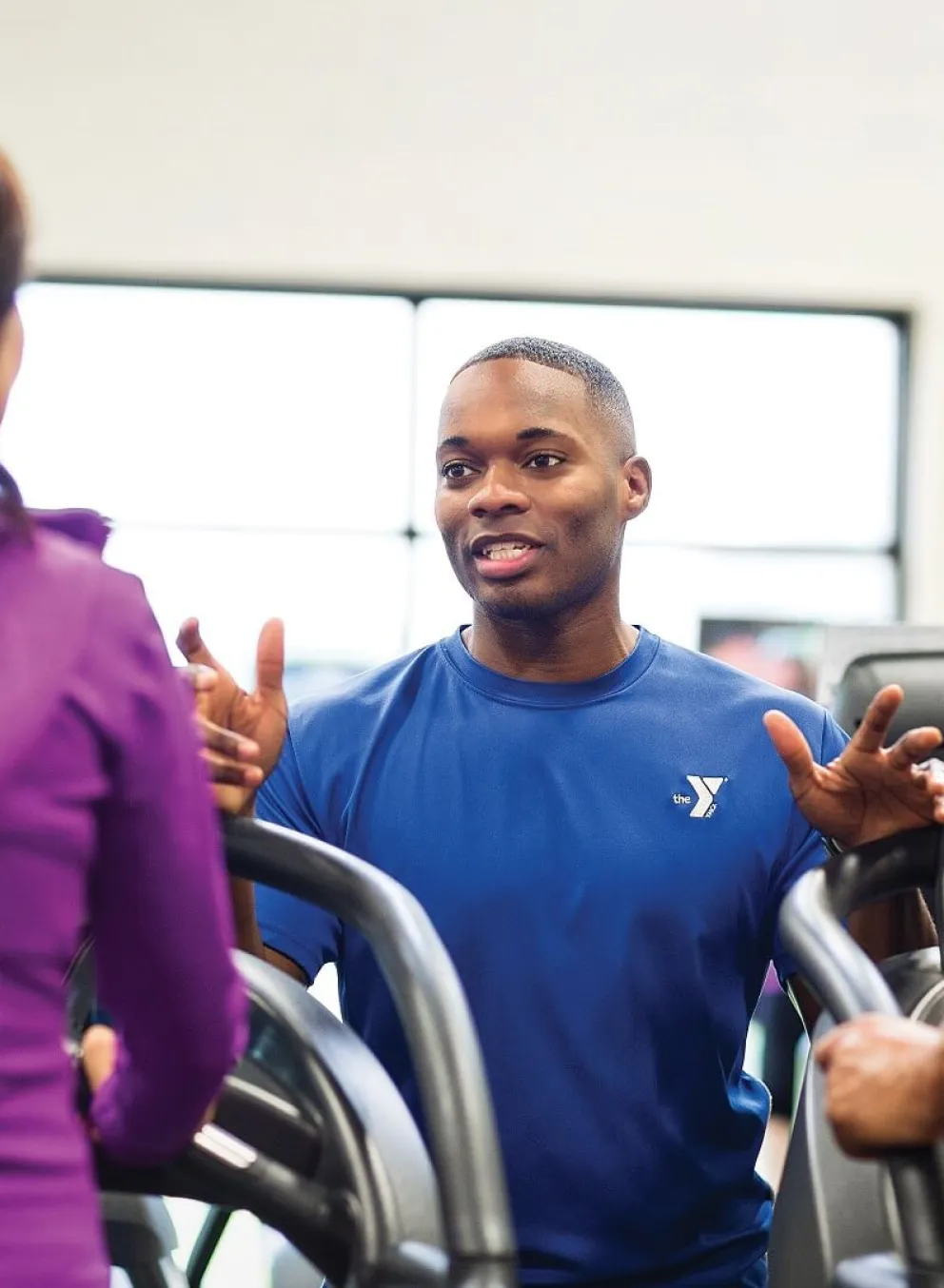 YMCA Louisville trainer coaching member for fitness assessment