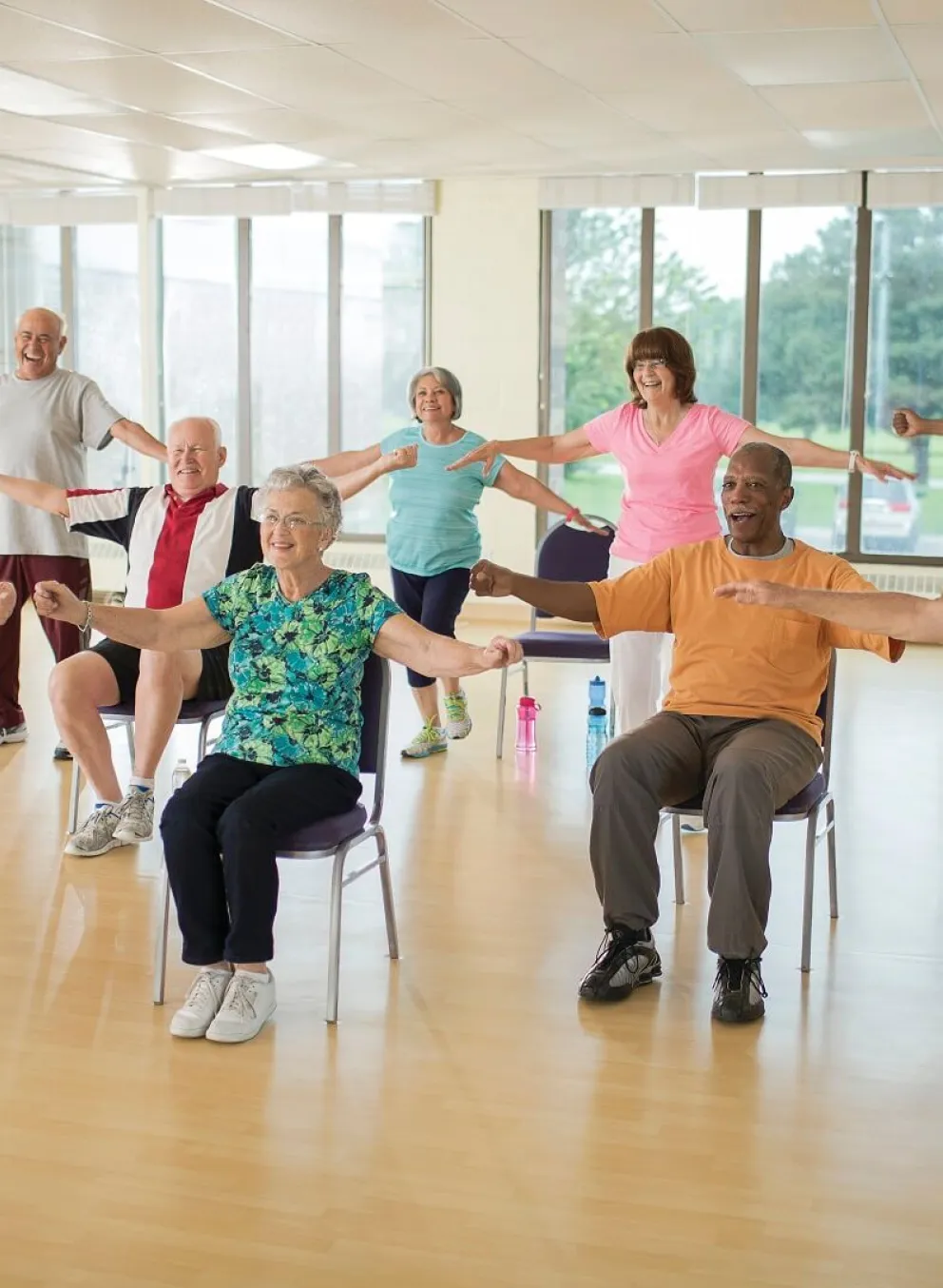 Group of older adults doing arm exercises at YMCA Louisville Forever Young fitness class