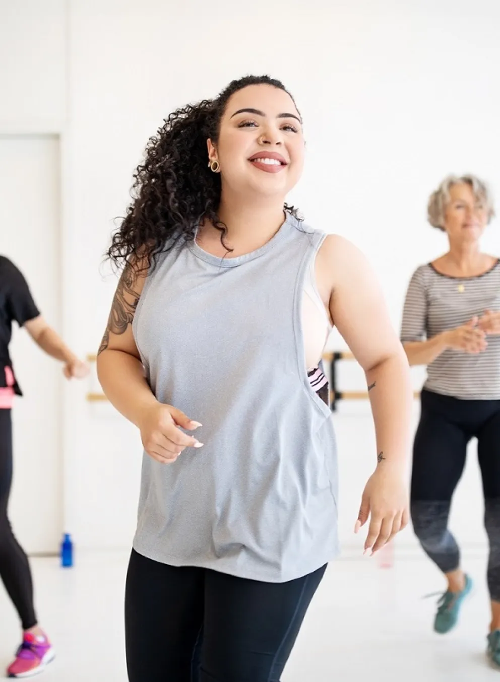 Adults and instructor flexing at group dance class at YMCA Louisville