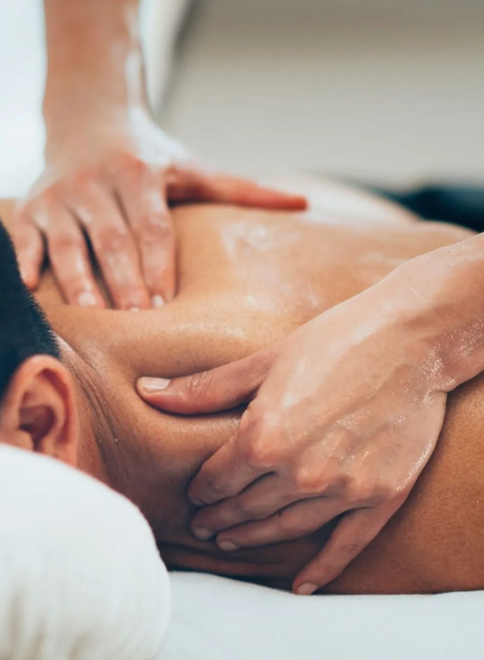 Man on massage table receiving shoulder massage