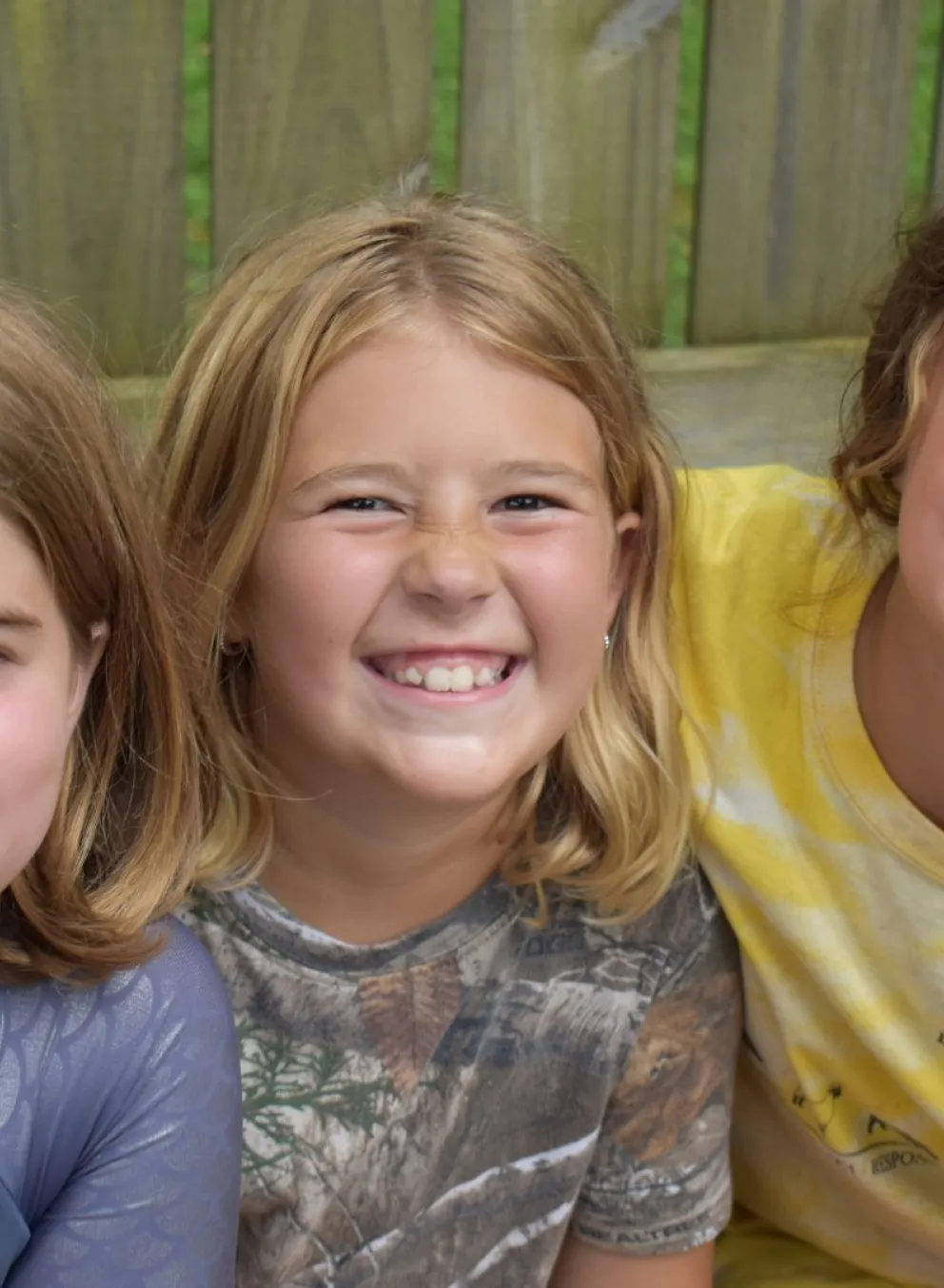 Group of campers sitting together smiling
