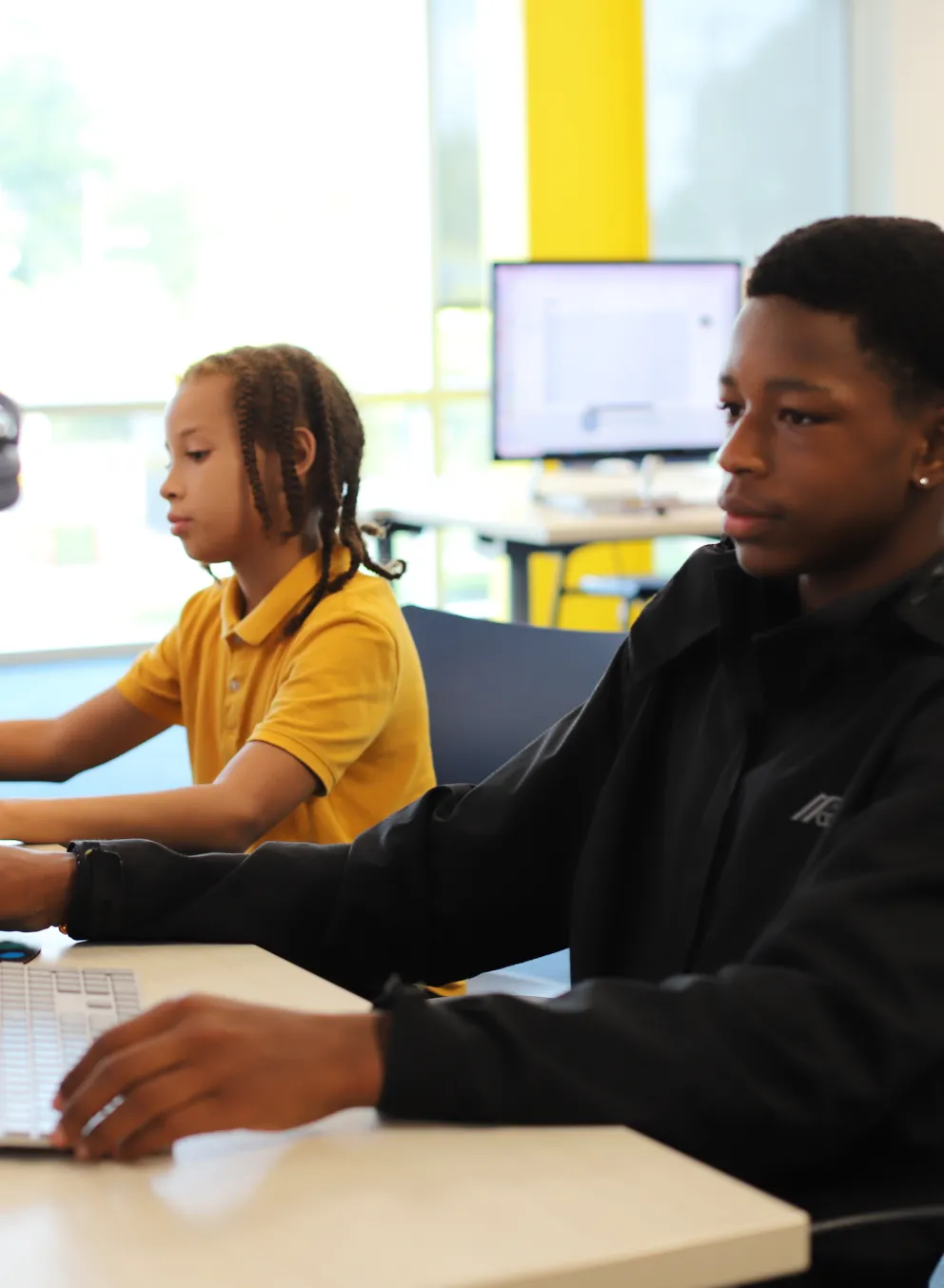Teens looking at computer screens