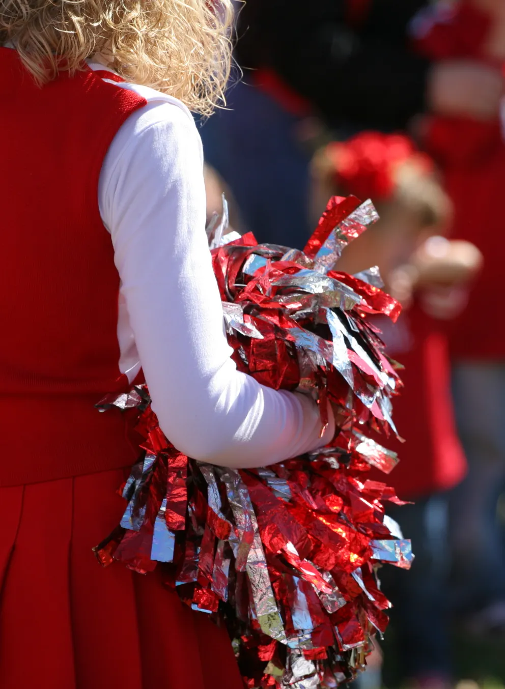 Cheerleader with pom poms