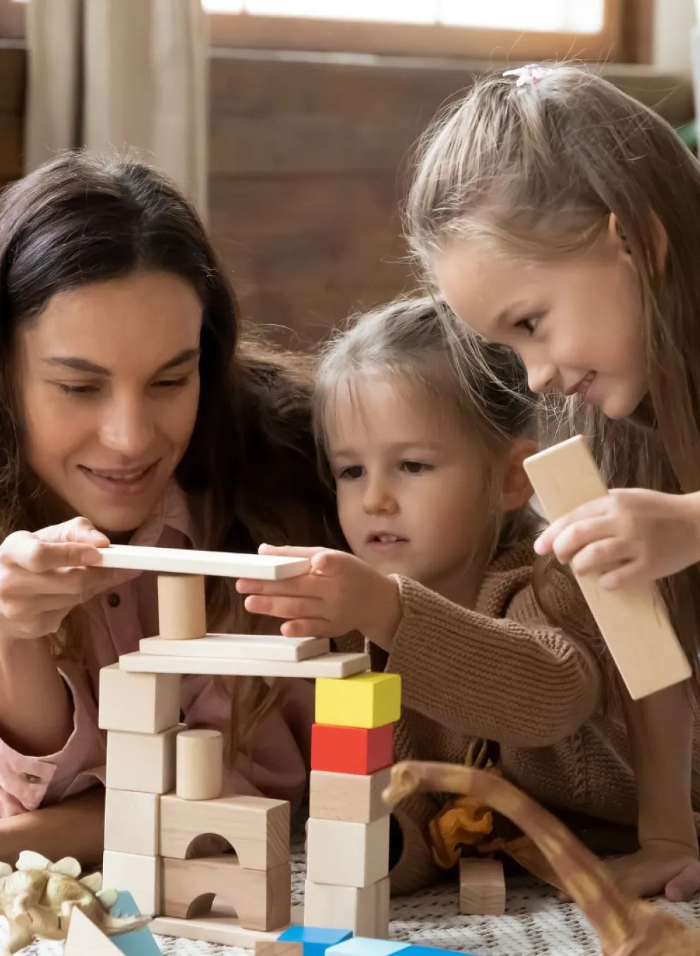 Babysitter playing blocks with kids