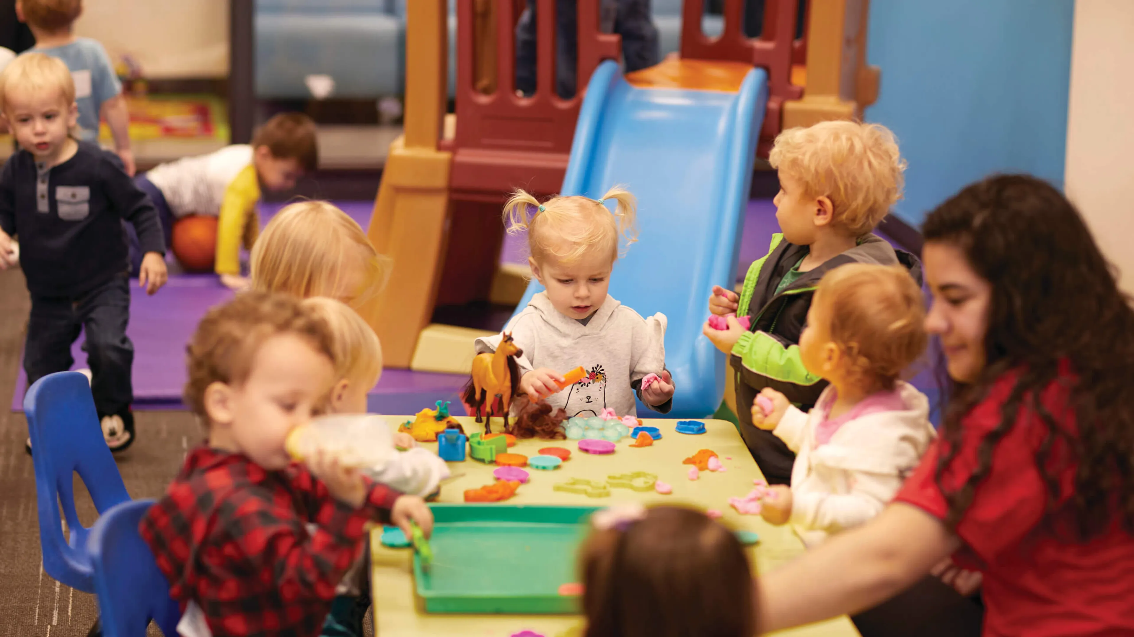 YMCA staff crafting with kids during child care program