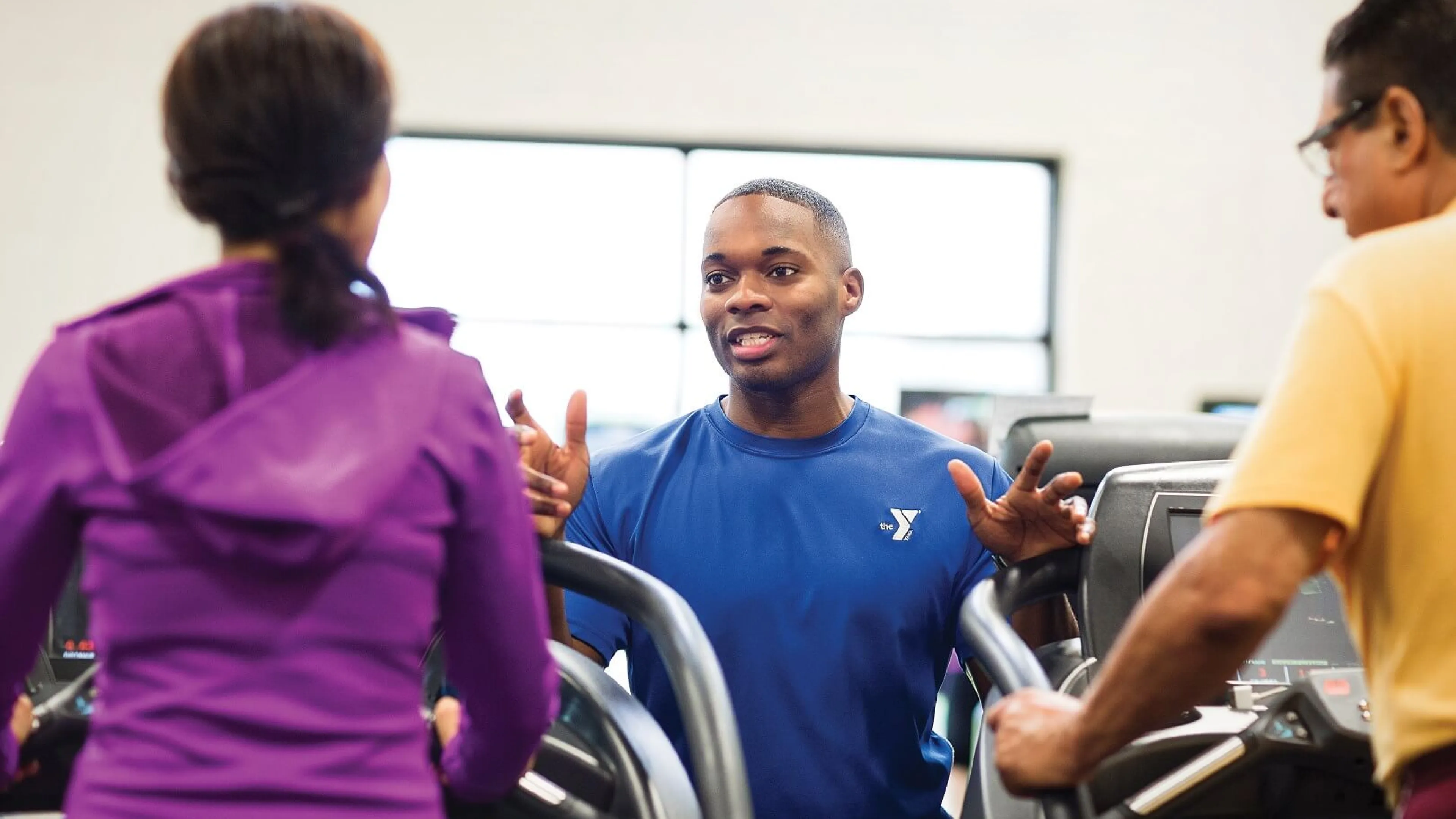 YMCA Louisville trainer coaching member for fitness assessment