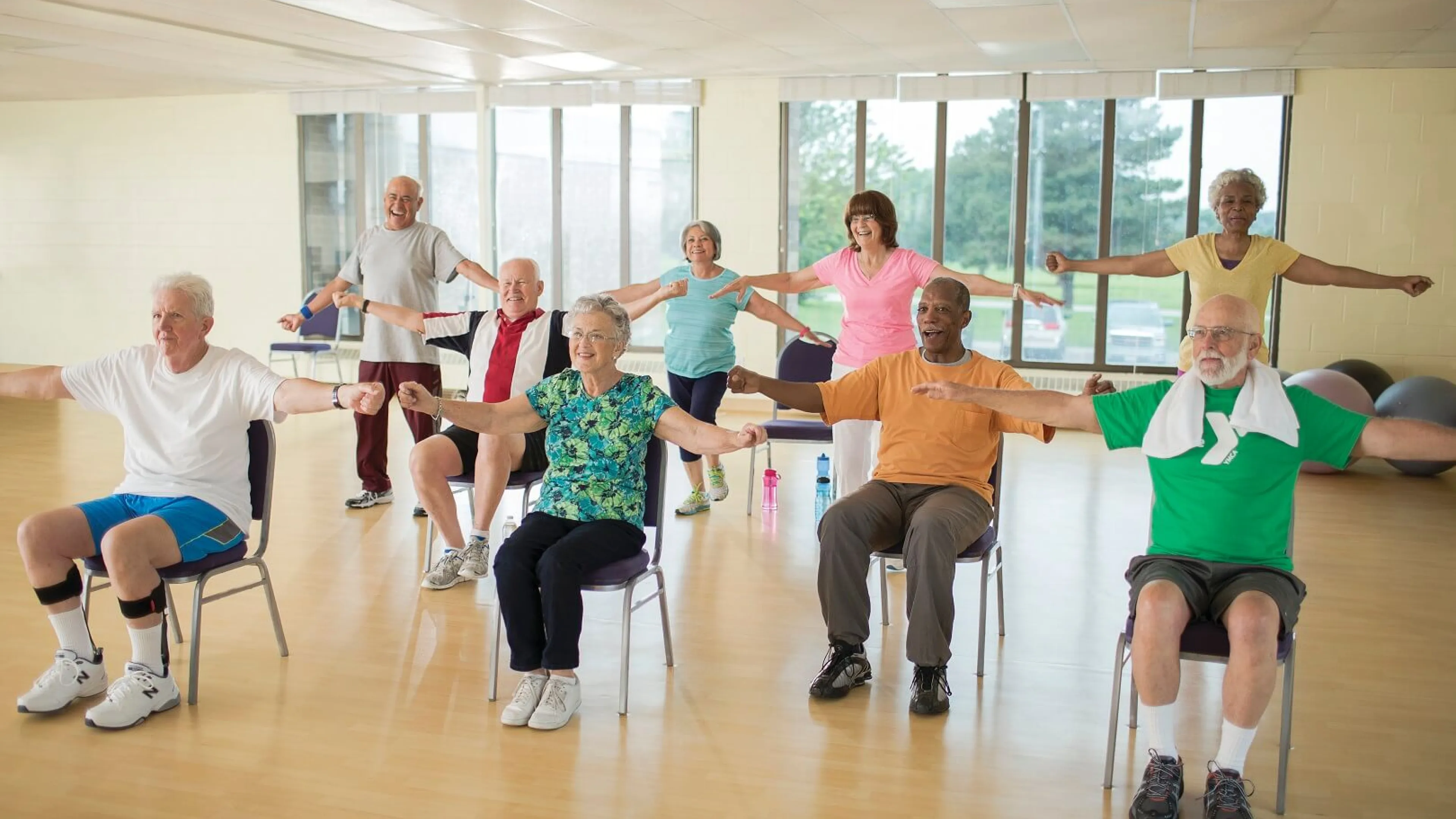 Group of older adults doing arm exercises at YMCA Louisville Forever Young fitness class