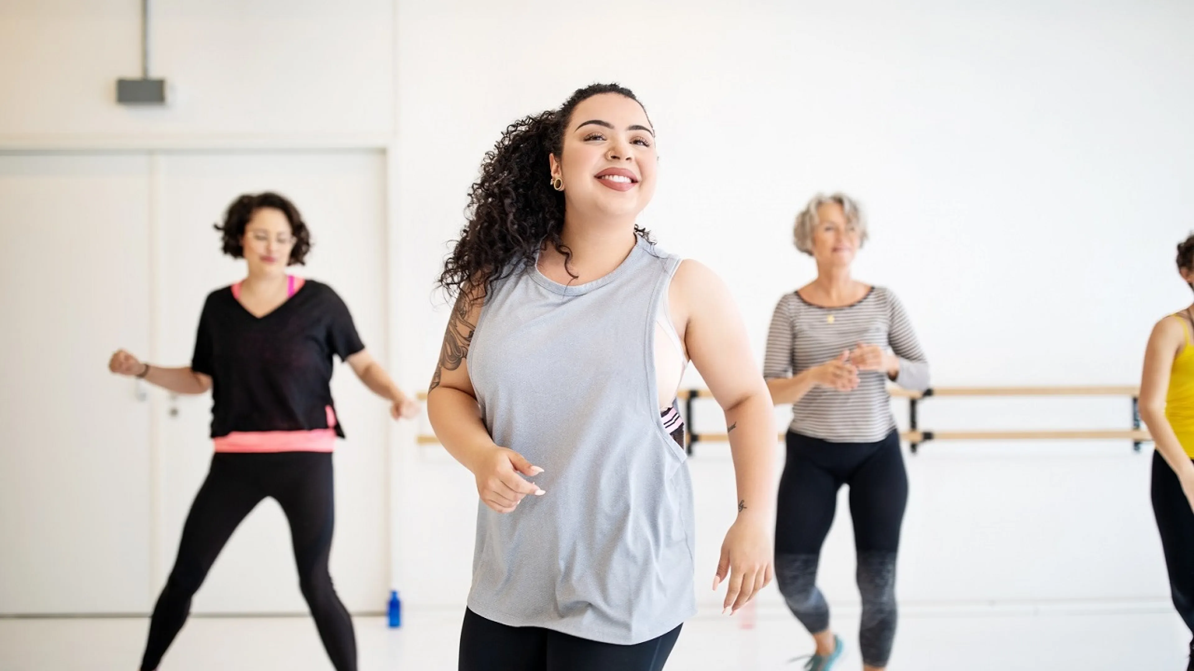 Adults and instructor flexing at group dance class at YMCA Louisville