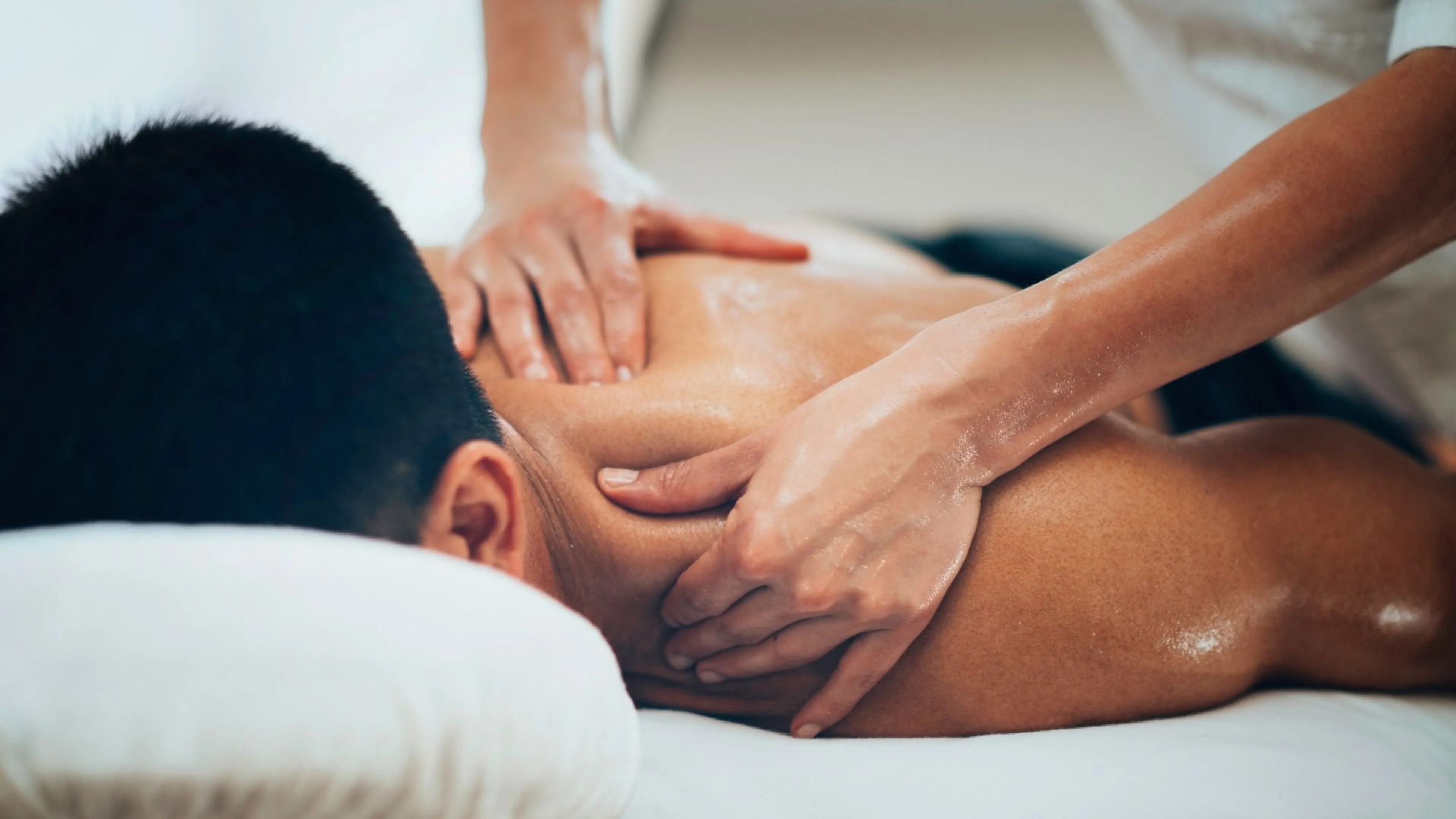 Man on massage table receiving shoulder massage