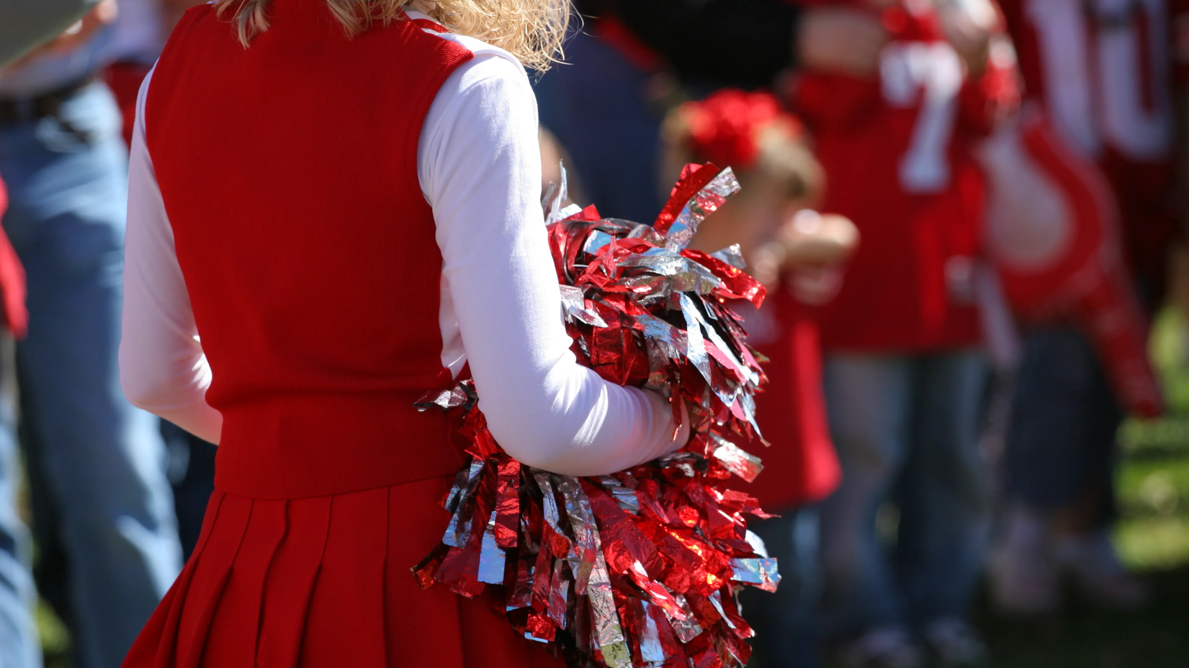 Cheerleader with pom poms